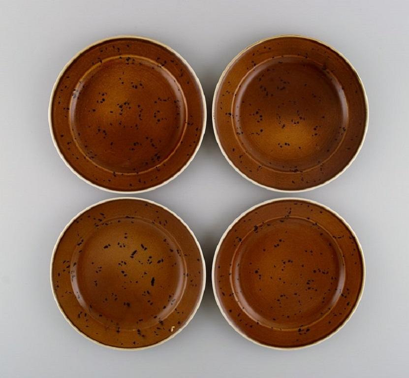 Stig Lindberg for Gustavsberg. 11 Coq lunch plates in glazed stoneware. 
Beautiful glaze in brown shades. Swedish design, 1960s.
Measure: Diameter: 20 cm.
In excellent condition.
Stamped.