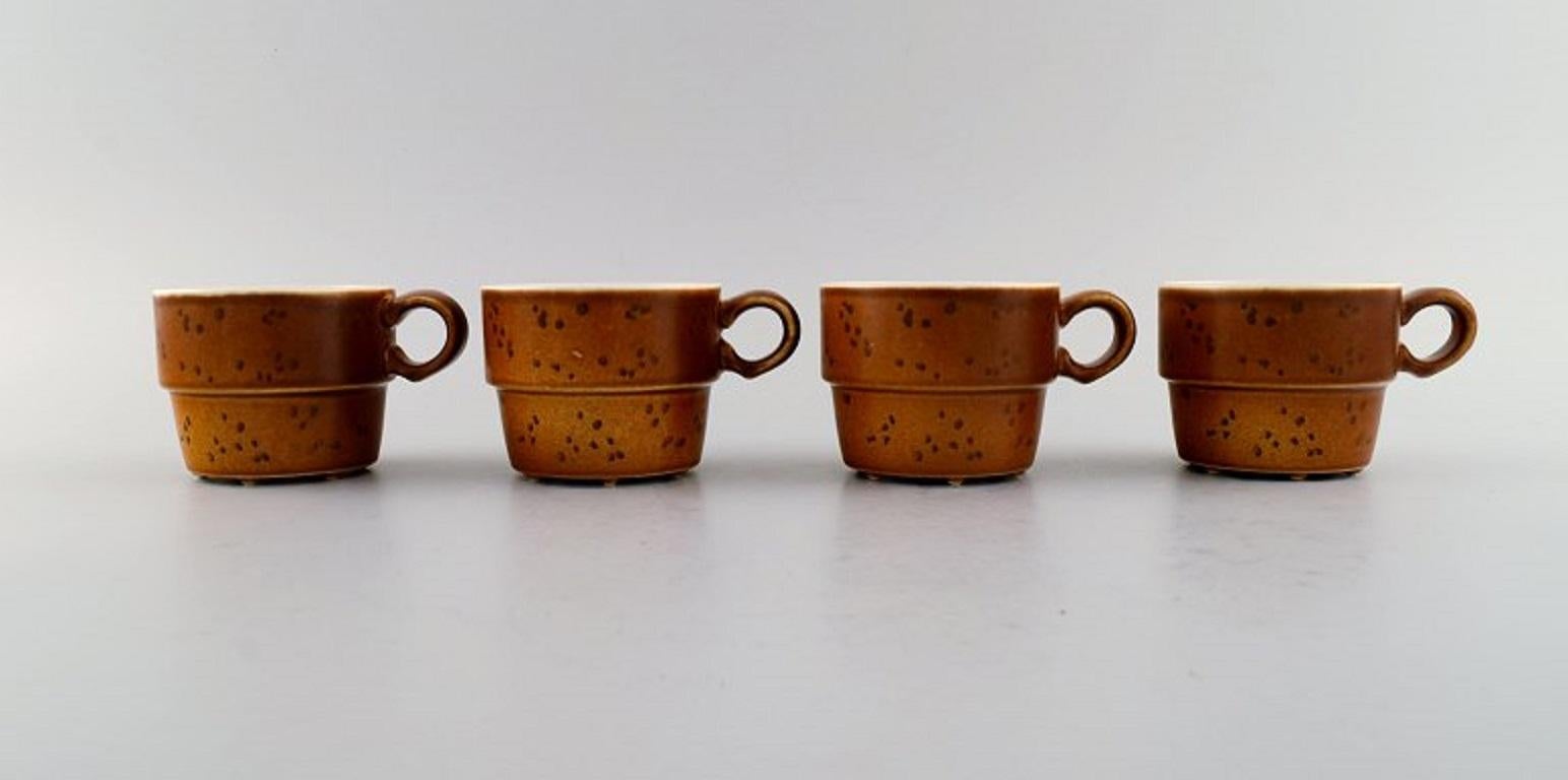 Stig Lindberg for Gustavsberg. 
Eight Coq coffee cups in glazed stoneware. Beautiful glaze in brown shades. 
Swedish design, 1960s.
Measures: 7.5 x 6 cm.
In excellent condition.
Stamped.
