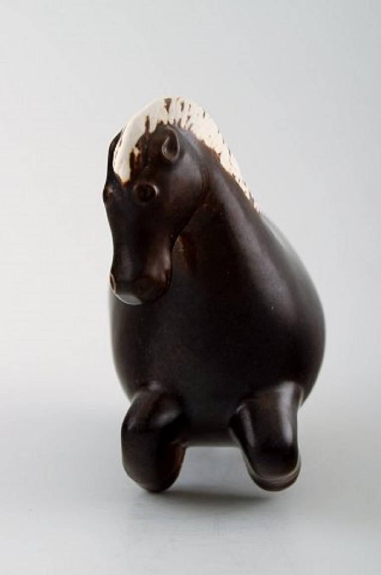 Stig Lindberg for Gustavsberg.
Horse figure of stoneware, decorated with brown glaze.
Made and marked for Gustavsberg, Sweden, 1950s.
Measures: Length 16 cm, height 12 cm.
