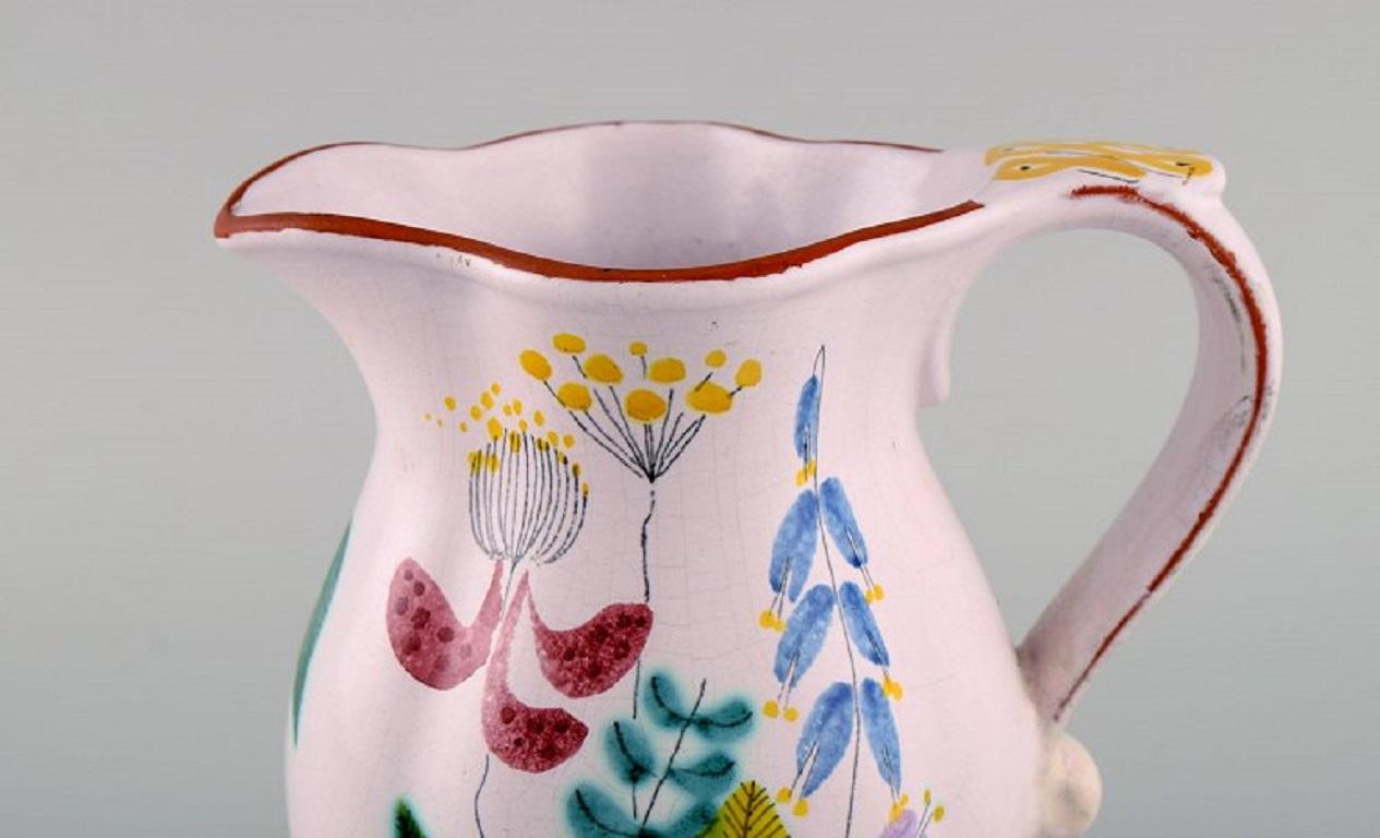 Stig Lindberg for Gustavsberg Studio Hand. Jug in glazed faience with hand-painted flowers. 1940s.
Measures: 16.5 x 15 cm.
In excellent condition.
Signed.