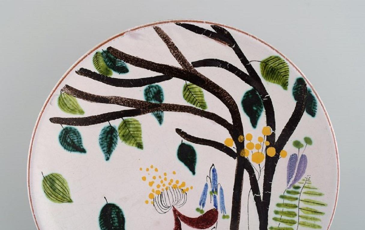 Stig Lindberg for Gustavsberg Studio, Sweden
Round dish in glazed faience with hand-painted flowers. 1940s.
Measures: 22 x 4.5 cm.
In excellent condition.
Signed.