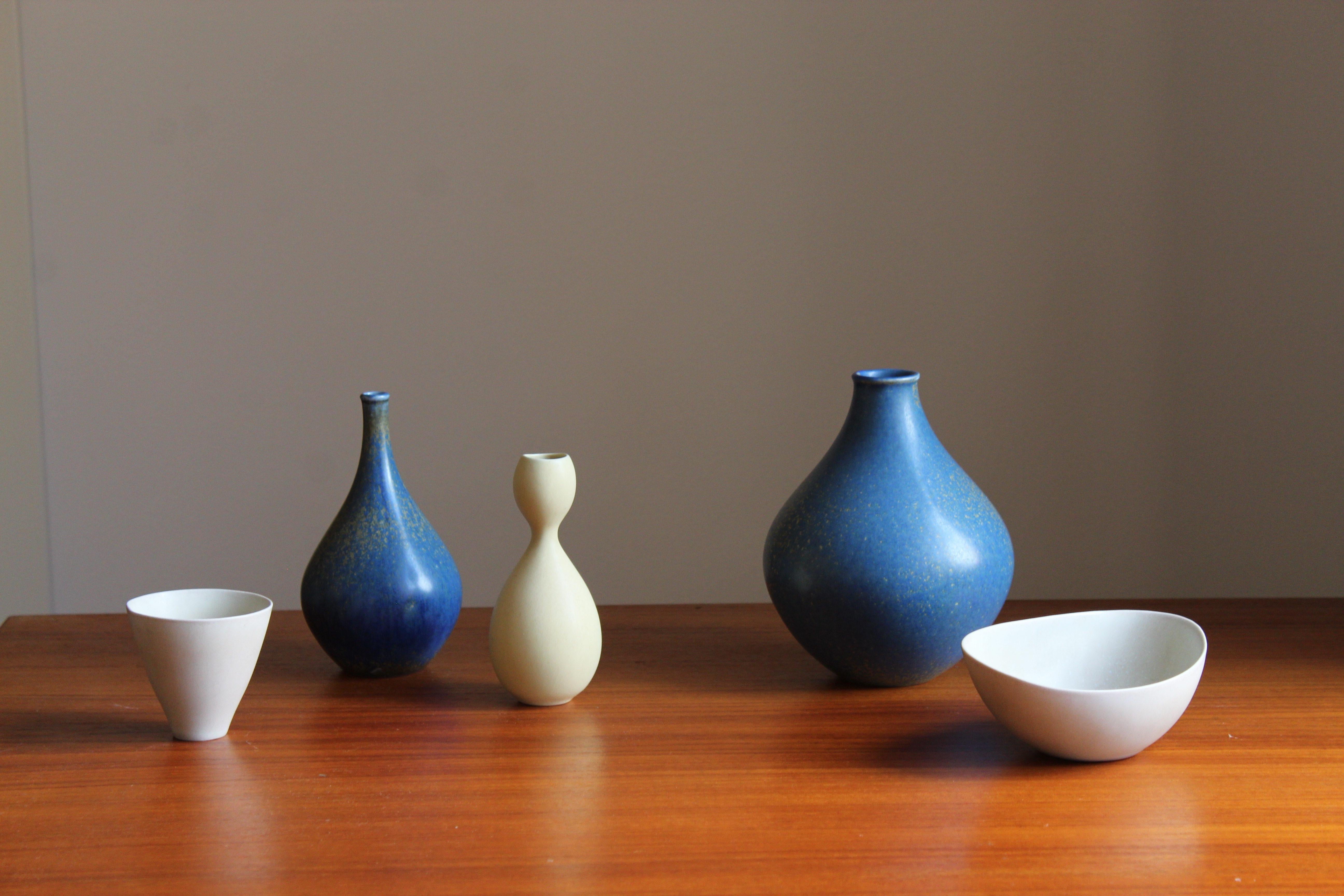 A collection of vases and a bowl. Designed by Stig Lindberg, 1950s. Produced by Gustavsberg.