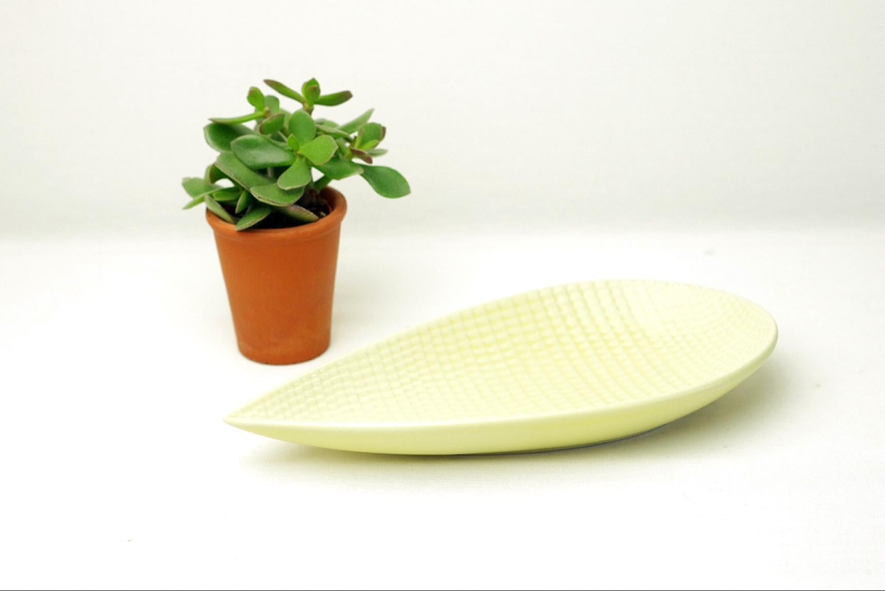 Product Description:
The reptil series of Stig Lindberg gets its name from the reptile-skin-like relief covering all its items. The reptil series consists of vases and plates all in pastel colors like light blue, light green, broken white but also