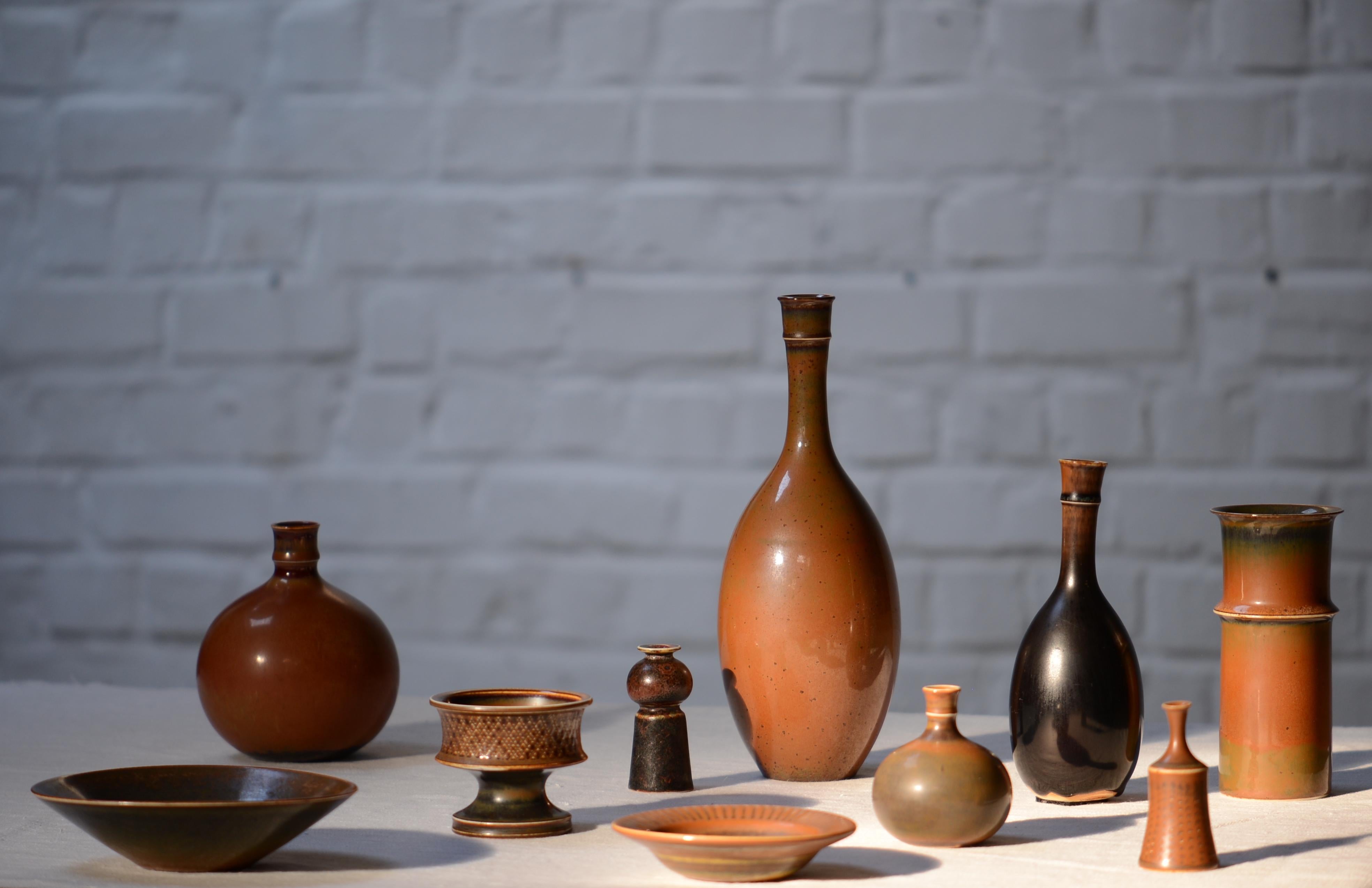 Set of 10 brown glazed by Swedish master Stig Lindberg in various size and shapes. From light brown to dark brown. It took a few years to complete this series. 

Stig Lindberg (17 August 1916 in Umeå, Sweden – 7 April 1982 in San Felice Circeo,