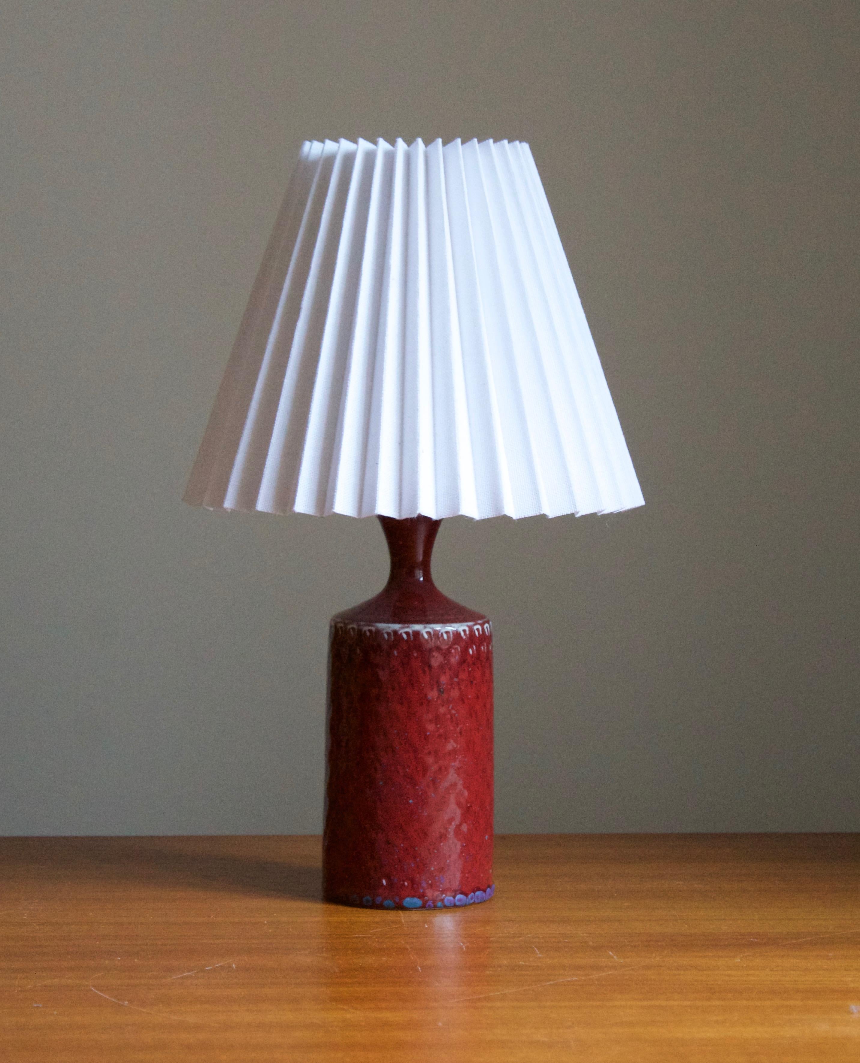 A table lamp mounted atop a vase designed and produced by Stig Lindberg. Produced by Gustavsberg. 

Marked with the Studio mark, separating this work from the large-scale production series by the maker.

Stated dimensions exclude lampshade.