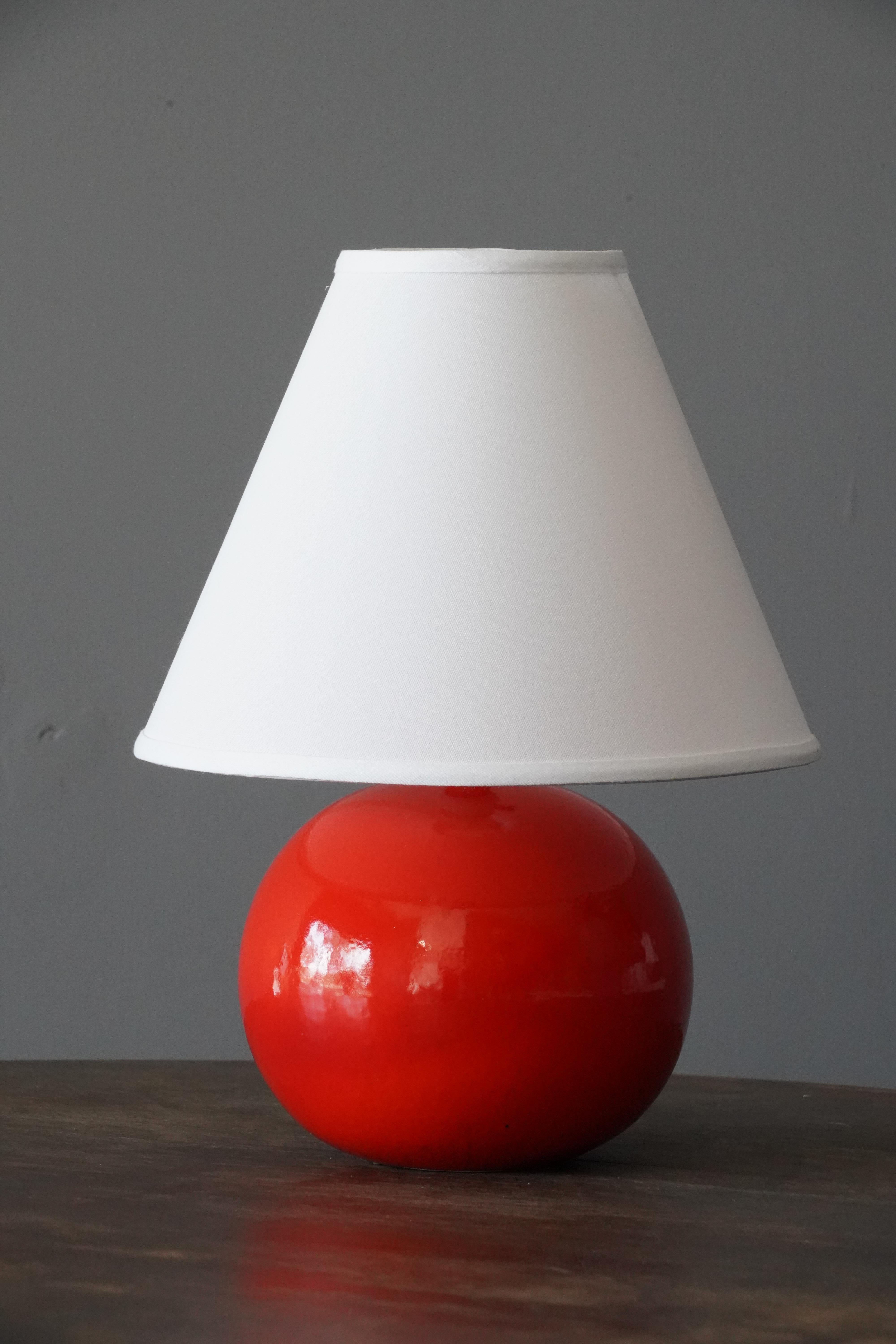 A table lamp or desk lamp designed by Stig Lindberg. Produced by Gustavsberg. 

With makers stamp

Stated dimensions exclude lampshade. Height includes socket. Sold without lampshade.

Glaze features a red color.

Other designers of the period