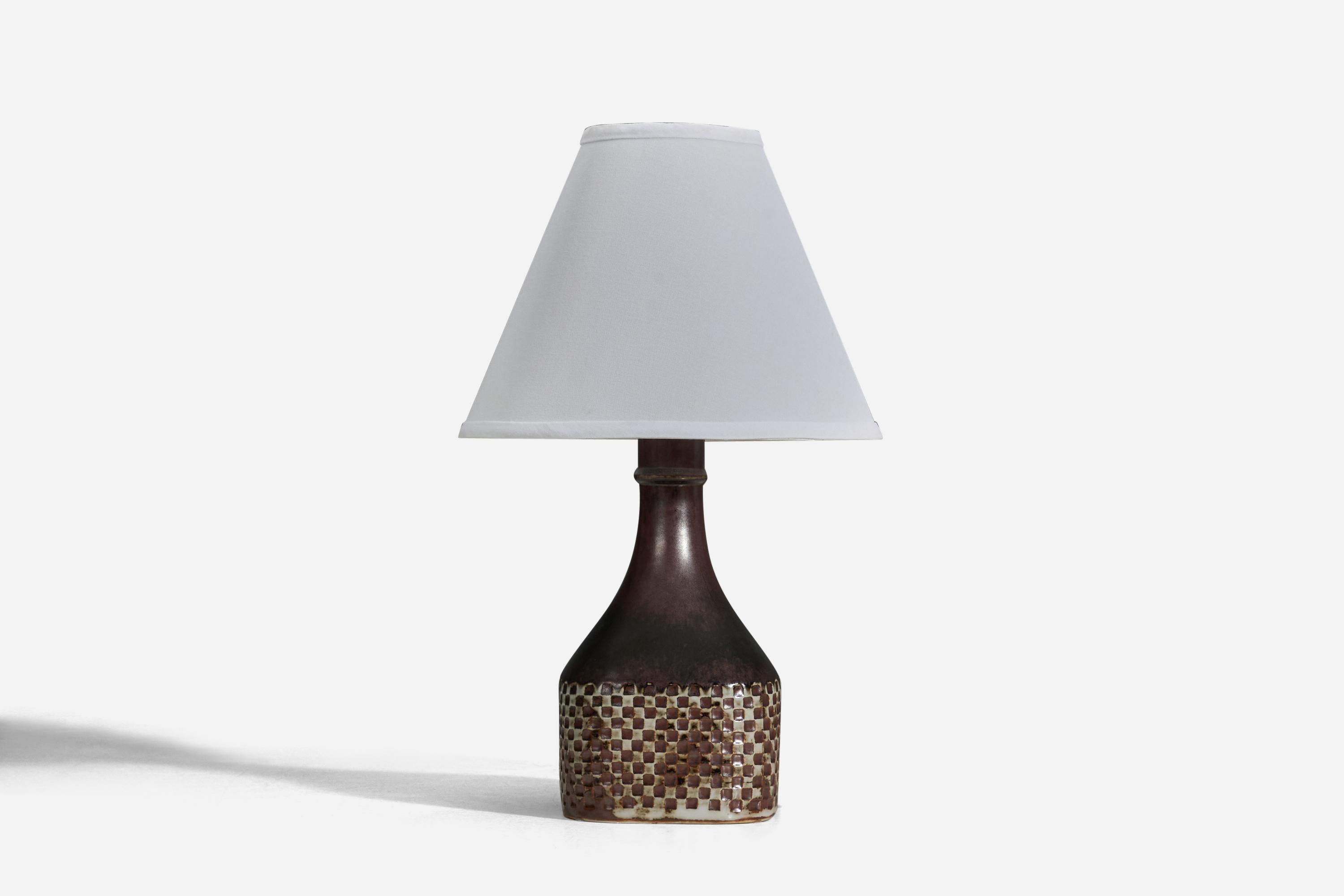 A brown glazed stoneware table lamp designed by Stig Lindberg and produced by Gustavsberg, Sweden, 1950s.

Sold without Lampshade
Dimensions of Lamp (inches) : 12 x 5.33 x 5.3 (Height x Width x Depth)
Dimensions of Lampshade (inches) : 4 x 10 x
