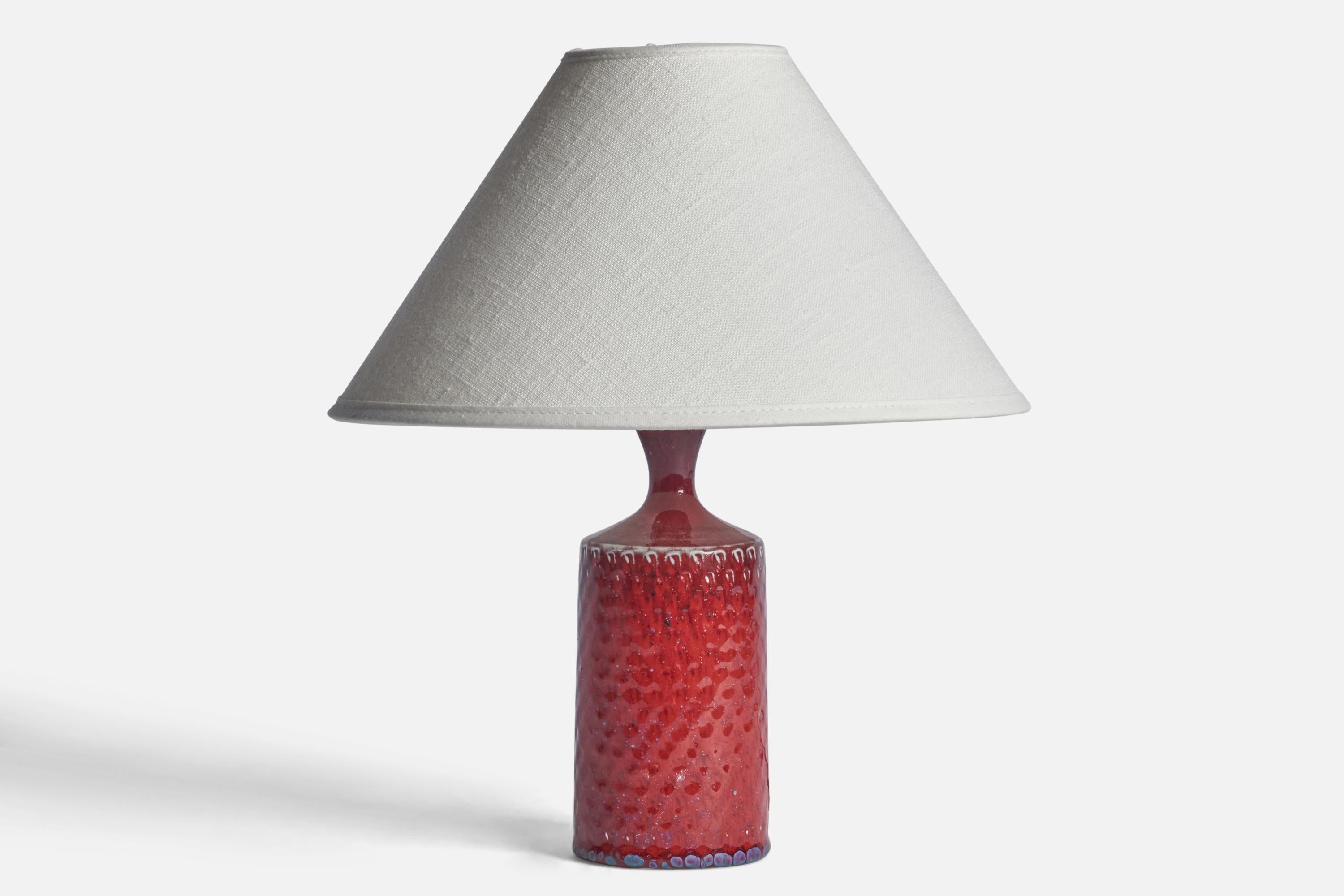 A red-glazed incised stoneware table lamp designed by Stig Lindberg and produced by Gustavsberg, Sweden, c. 1950s.

Dimensions of Lamp (inches): 8.5” H x 2.75” Diameter
Dimensions of Shade (inches): 2.5” Top Diameter x 10” Bottom Diameter x