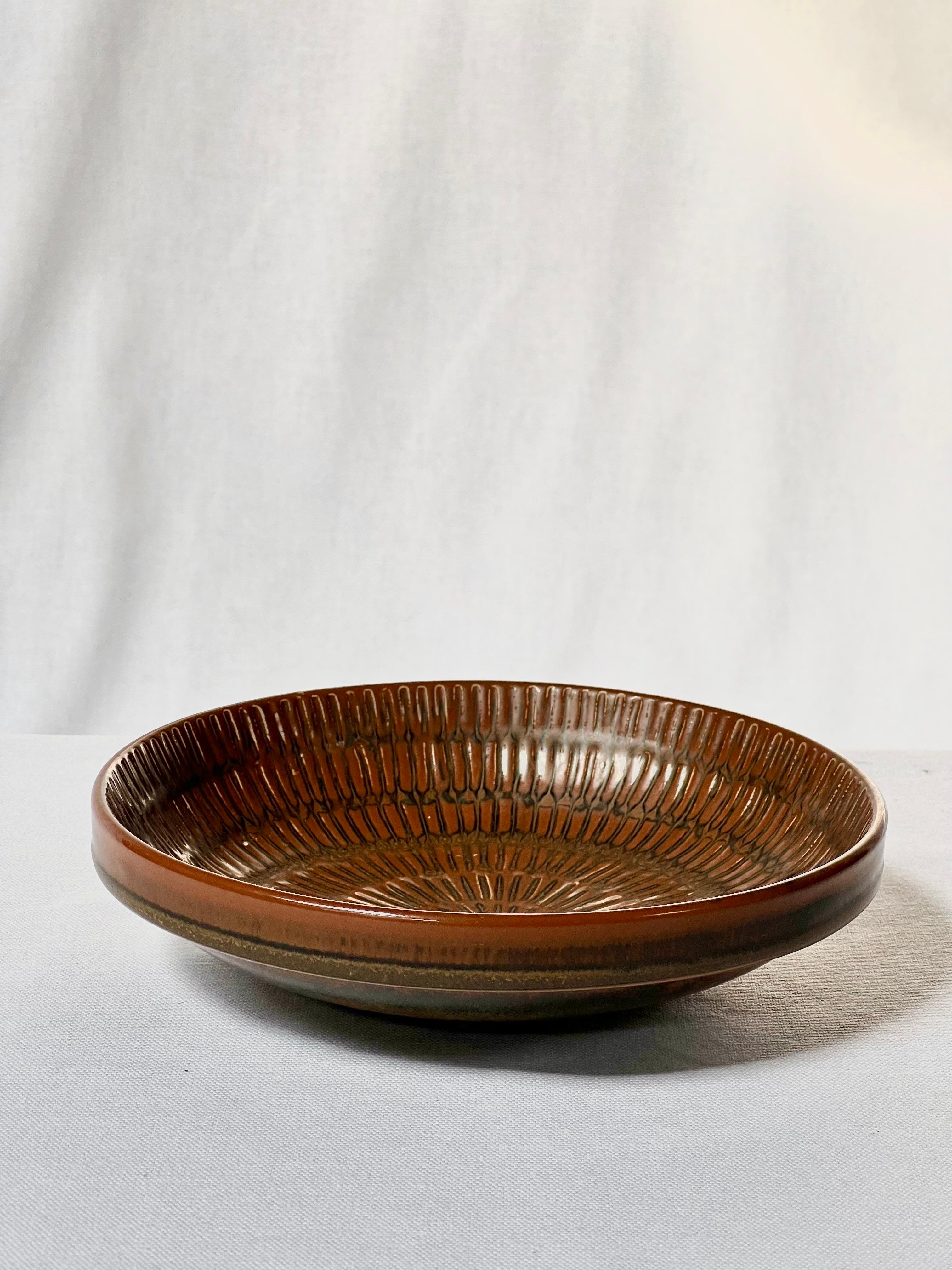 Brown glazed bowl / vide poche by Swedish master ceramicist Stig Lindberg. From light brown to dark brown. Elegant details and nice pattern. Unique piece made by hand and signed by the artist.



Stig Lindberg (17 August 1916 in Umeå, Sweden – 7