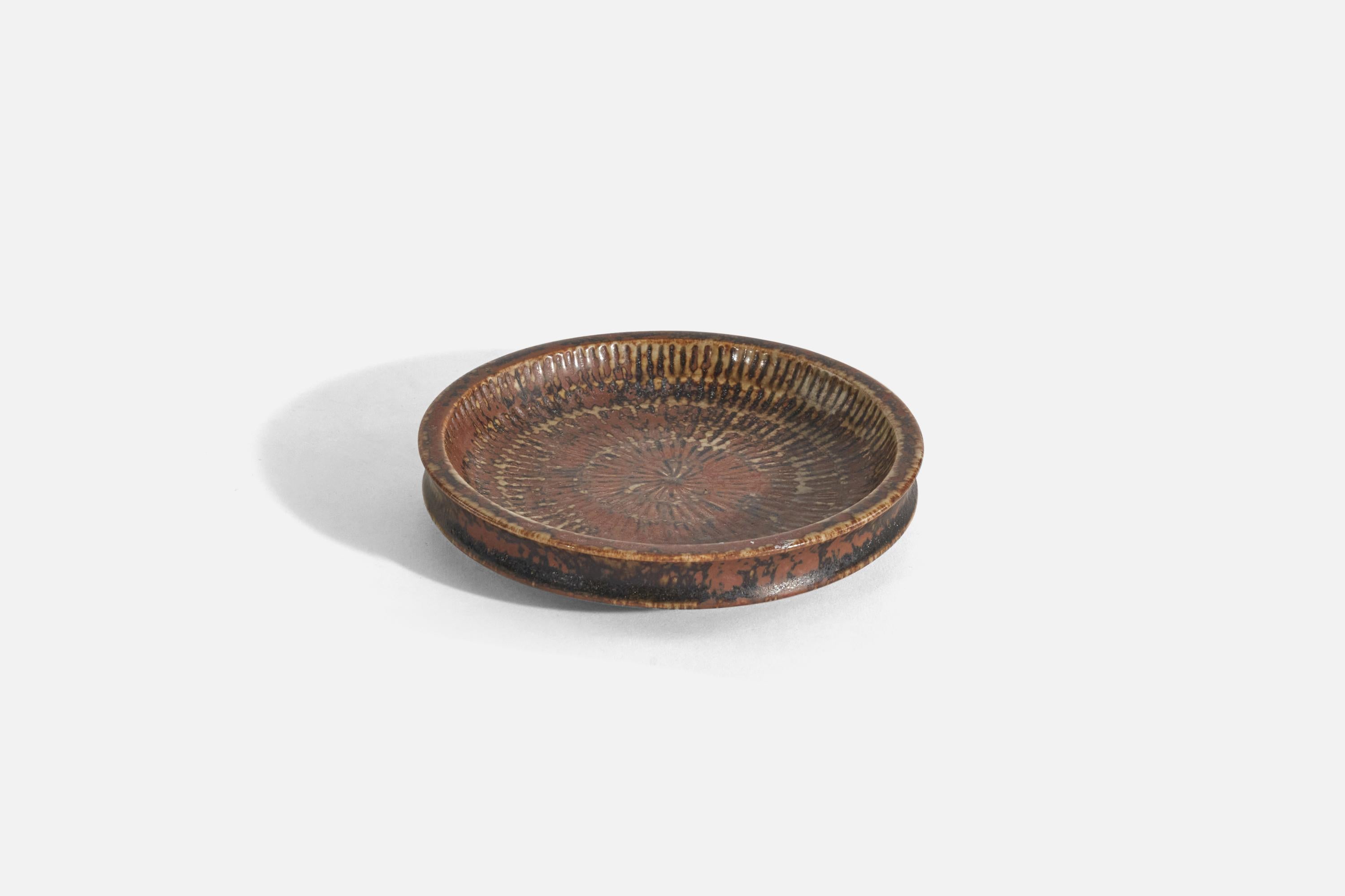 A brown, glazed stoneware decorative dish designed by Stig Lindberg and produced by Gustavsberg, Sweden, 1960s. 

