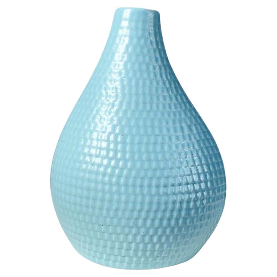 Stig Lindberg light blue ‚Reptile‘ vase designed in 1953 and manufactured at Gustavsberg in Sweden, produced until 1963.

Stoneware with relief pattern in light blue glaze. Stamped underneath.

Height: 18 cm
Width: 13 cm
Depth: 8 cm