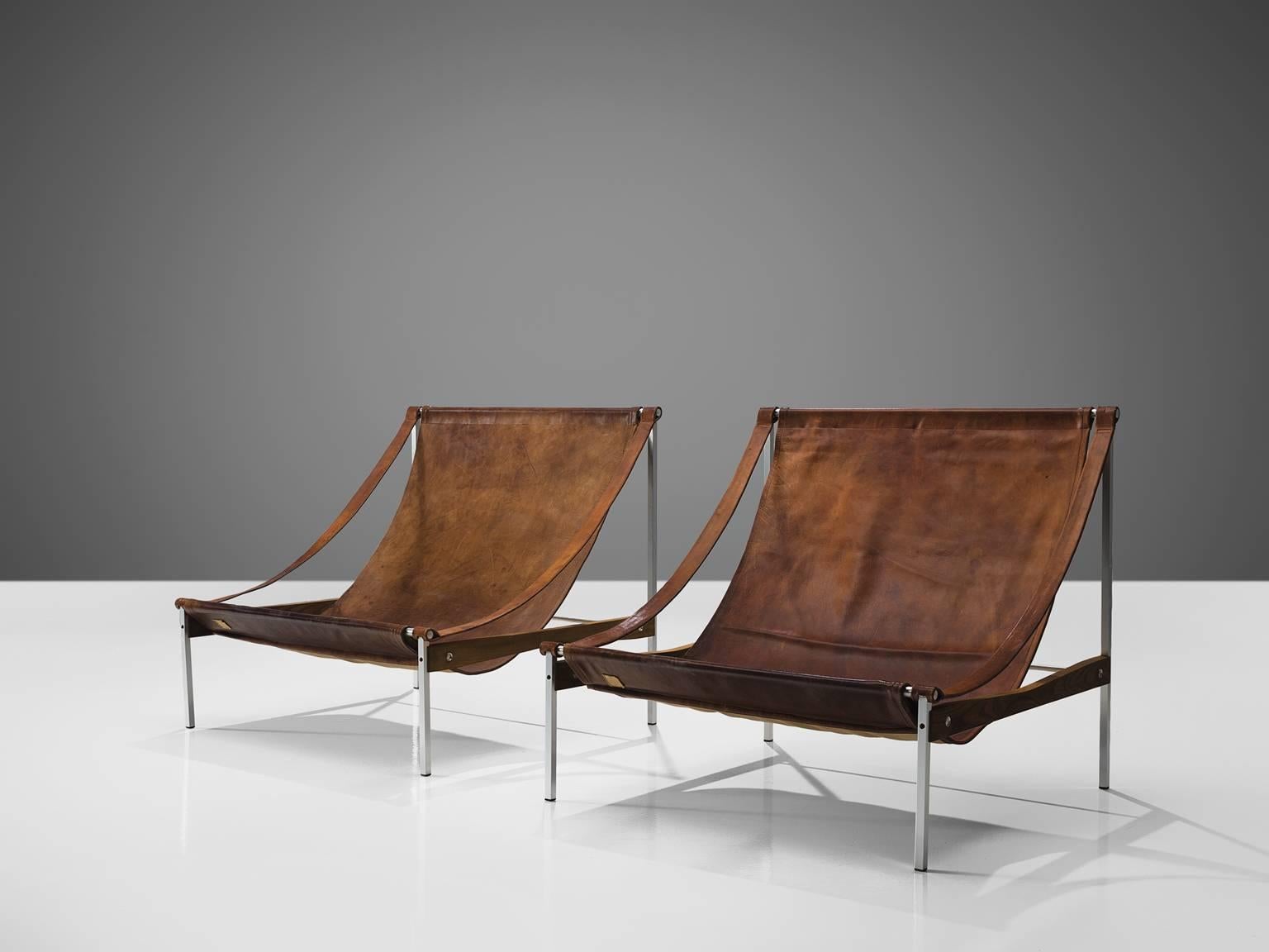 Stig Poulsson, lounge chair 'Bequem', cognac leather, steel, ash, Denmark, design 1968-69.

This grand set of 'Bequem' lounge chairs is designed by Stig Poulsson for Stig P.  The most striking feature of this extraordinary set is its sheer size. The