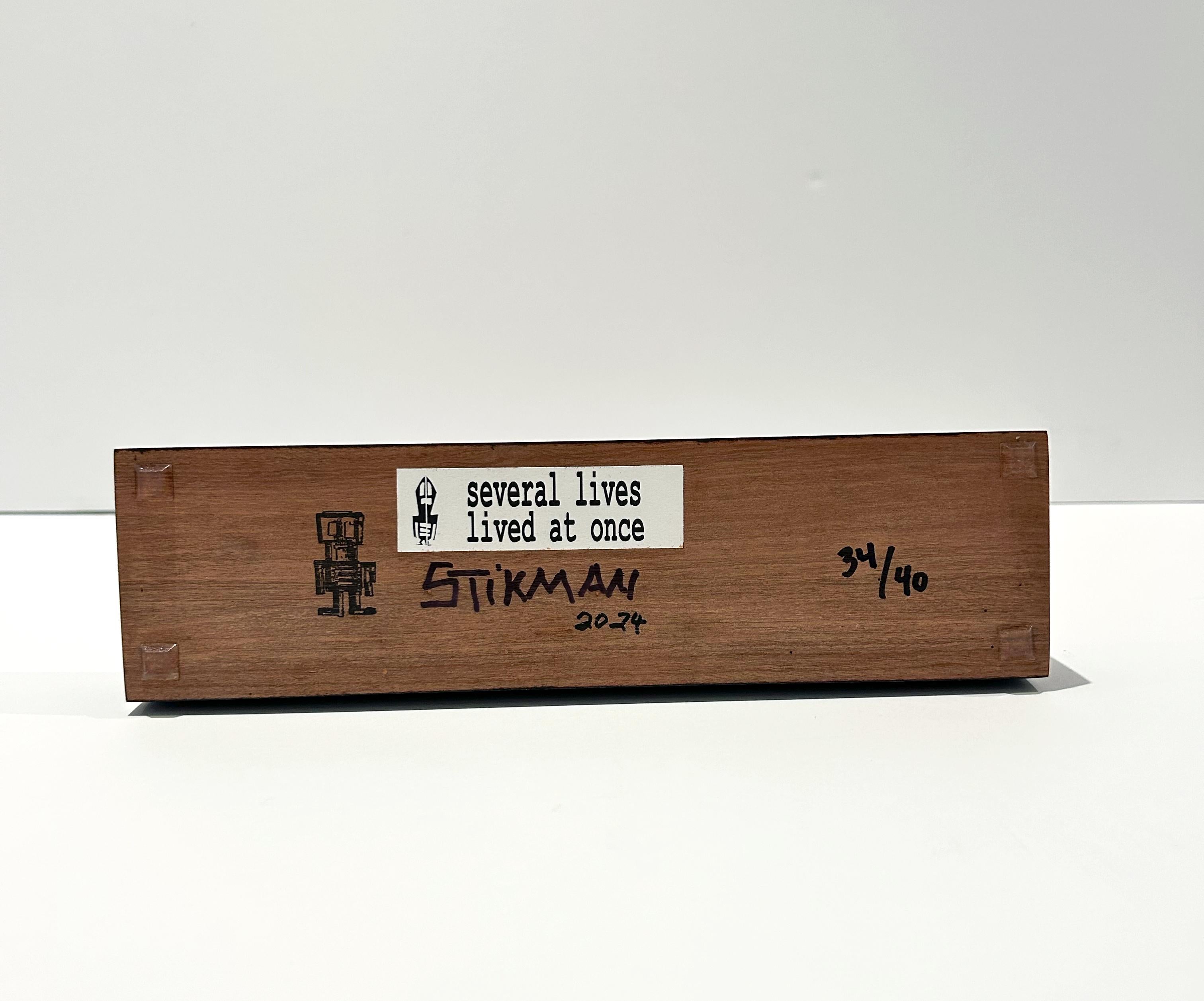 Artist: Stikman
Title: Several Lives Lived at Once
Medium: Laser cut powder-coated steel sculpture on wood base
Date: 2024
Edition: 34/40
Size: 15 1/2