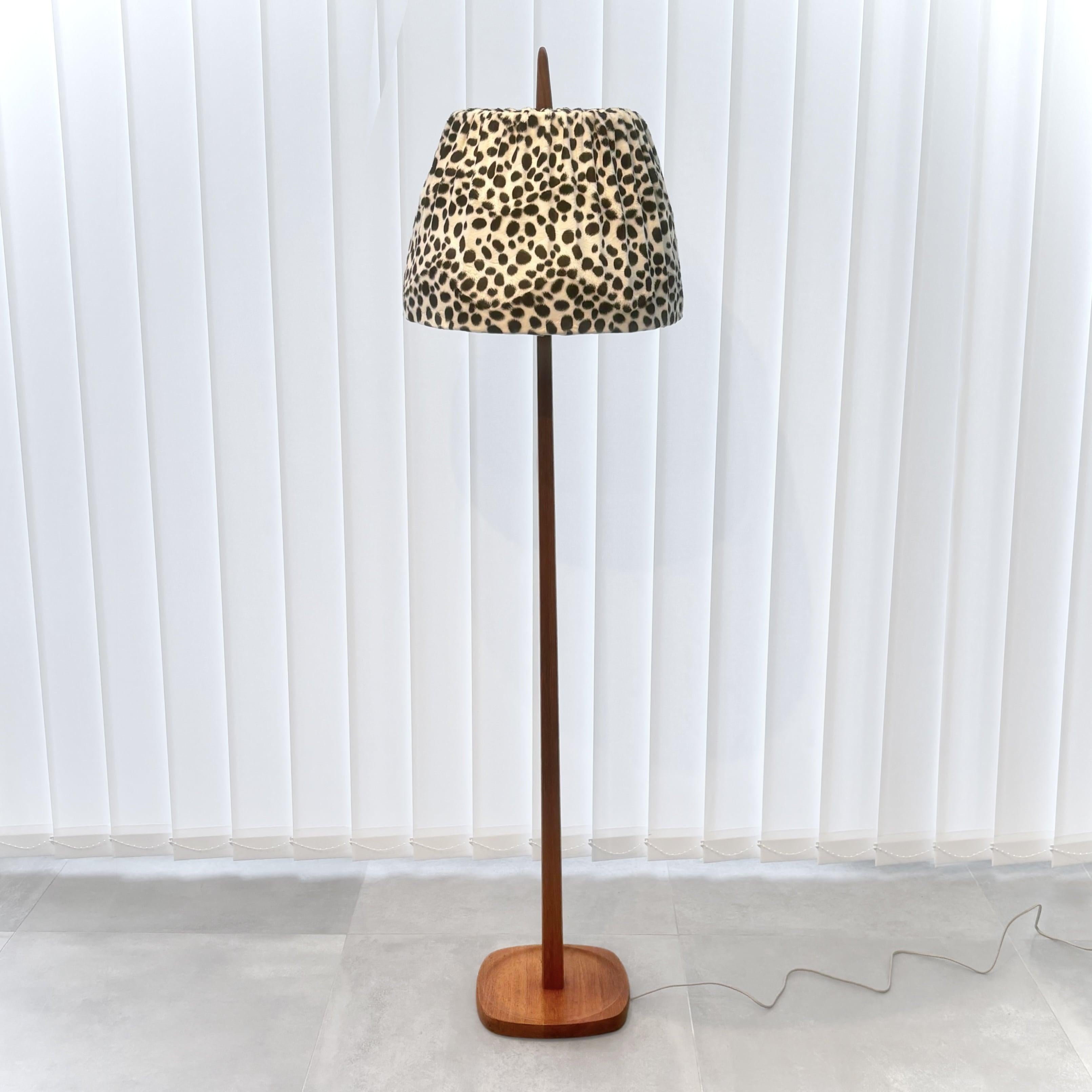 A Swedish 1960s floor lamp produced by the manufacturer Stilarmatur, once located in the small town of Tranås. Crafted from solid teak with soft lines and a sculptural foot. The shade is covered in faux dalmatian fur and has an inner layer of