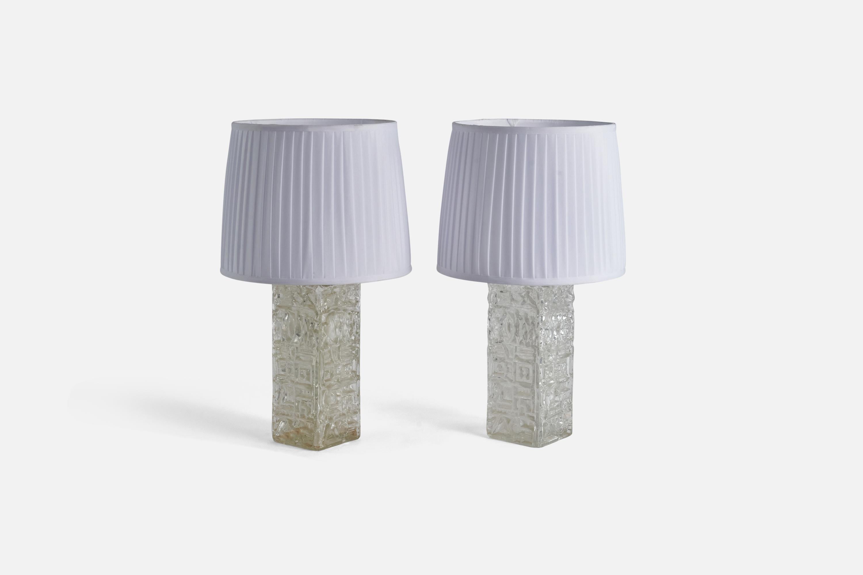 A pair of glass and white fabric table lamps designed and produced by AB Stilarmatur, Tranås, Sweden, 1960s. 

Sold with Lampshade(s).
Dimensions of Lamp (inches) : 16 x 4.62 x 4.62 (Height x Width x Depth)
Dimensions of Shade (inches) : 11.12 x 13