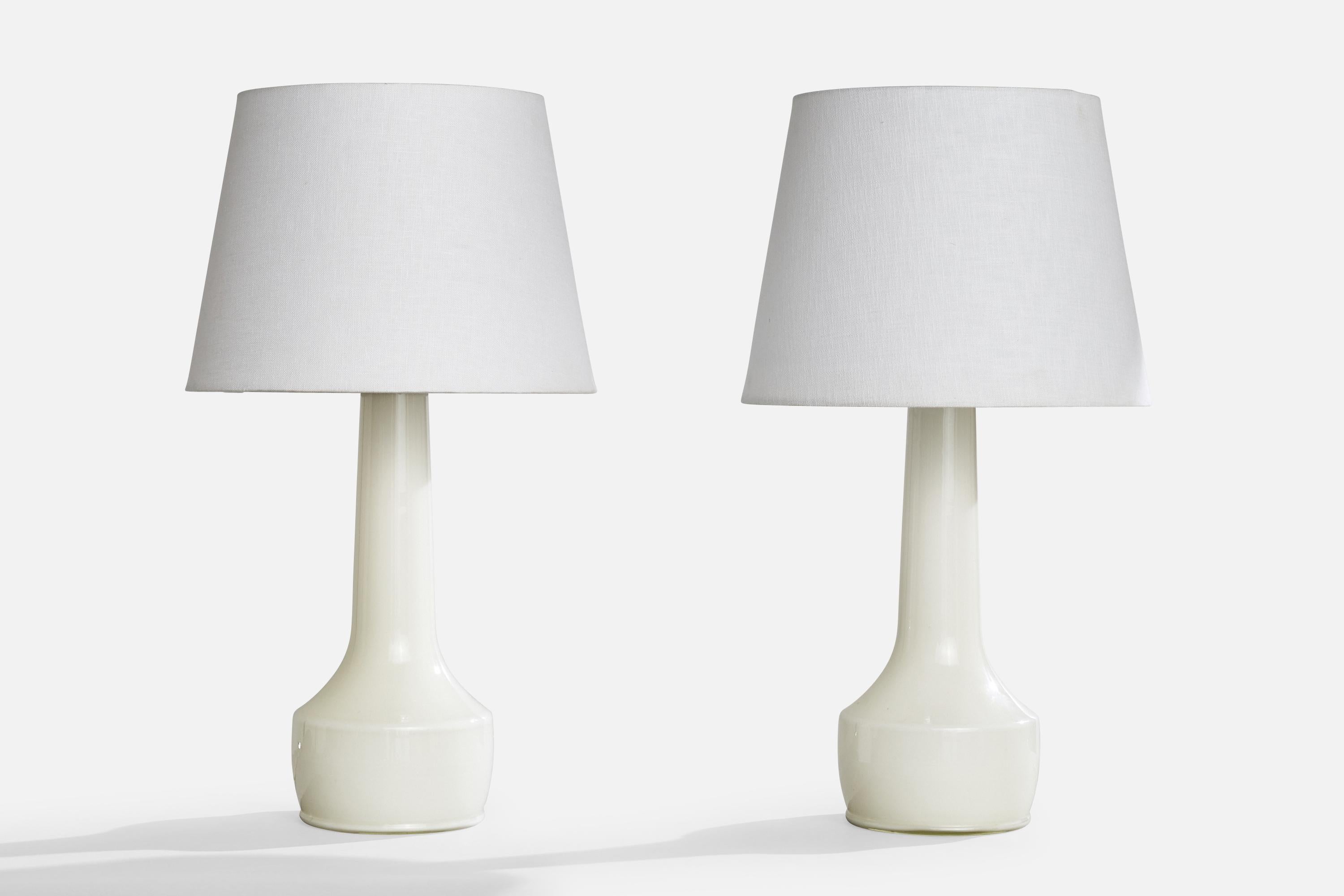 A pair of white opaline and brass table lamps produced by Stilarmatur Tranås, Sweden, c. 1960s.

Dimensions of Lamp (inches): 16.5“ H x 6“ Diameter

Dimensions of Shade (inches): 9” Top Diameter x 12“ Bottom Diameter x 9“ H

Dimensions of Lamp with