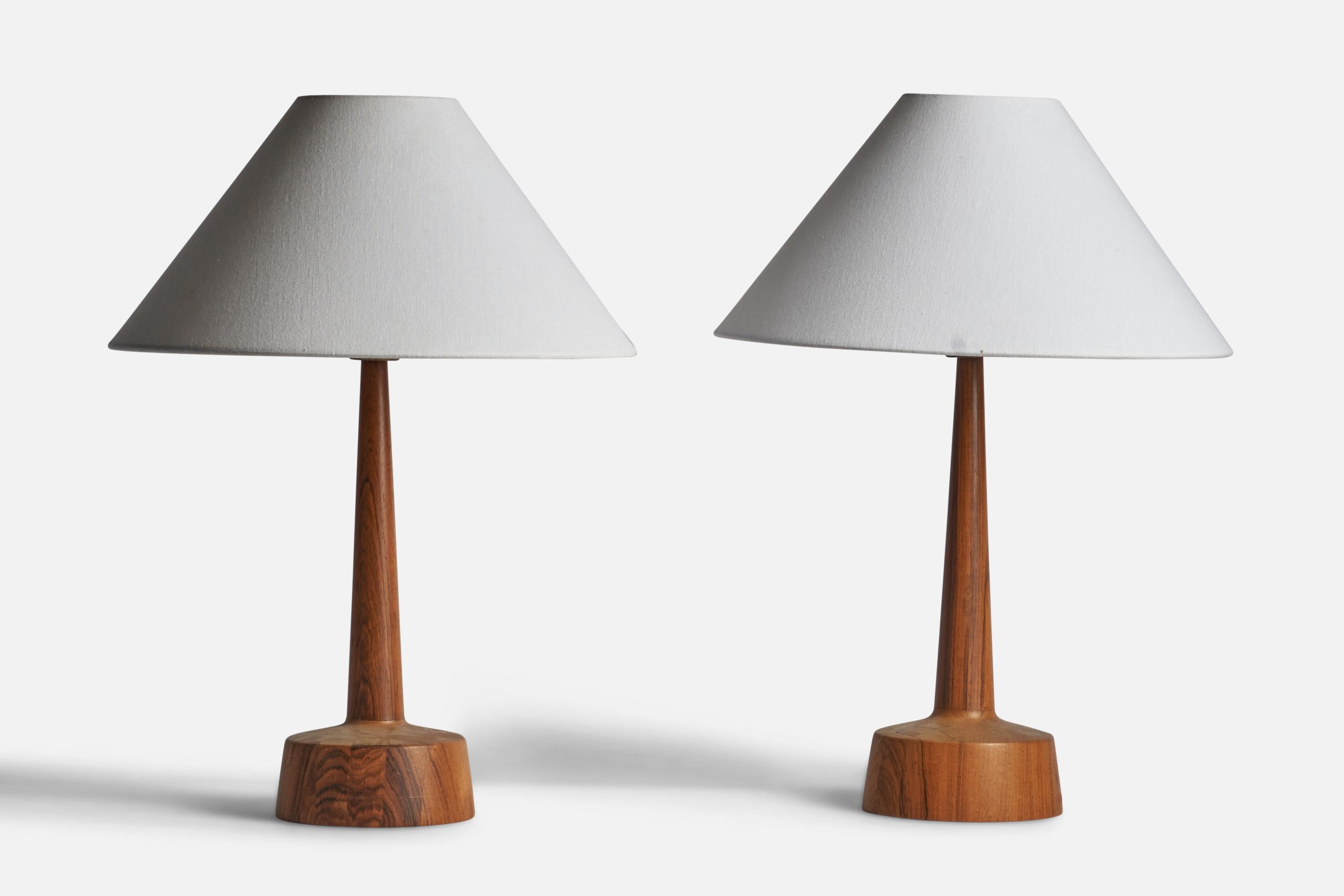 A pair of rosewood table lamps designed and produced by Stilarmatur Tranås, Sweden, 1960s.

Dimensions of Lamp (inches): 17” H x 6.15” Diameter
Dimensions of Shade (inches): 4.5” Top Diameter x 16” Bottom Diameter x 7.75” H 
Dimensions of Lamp with