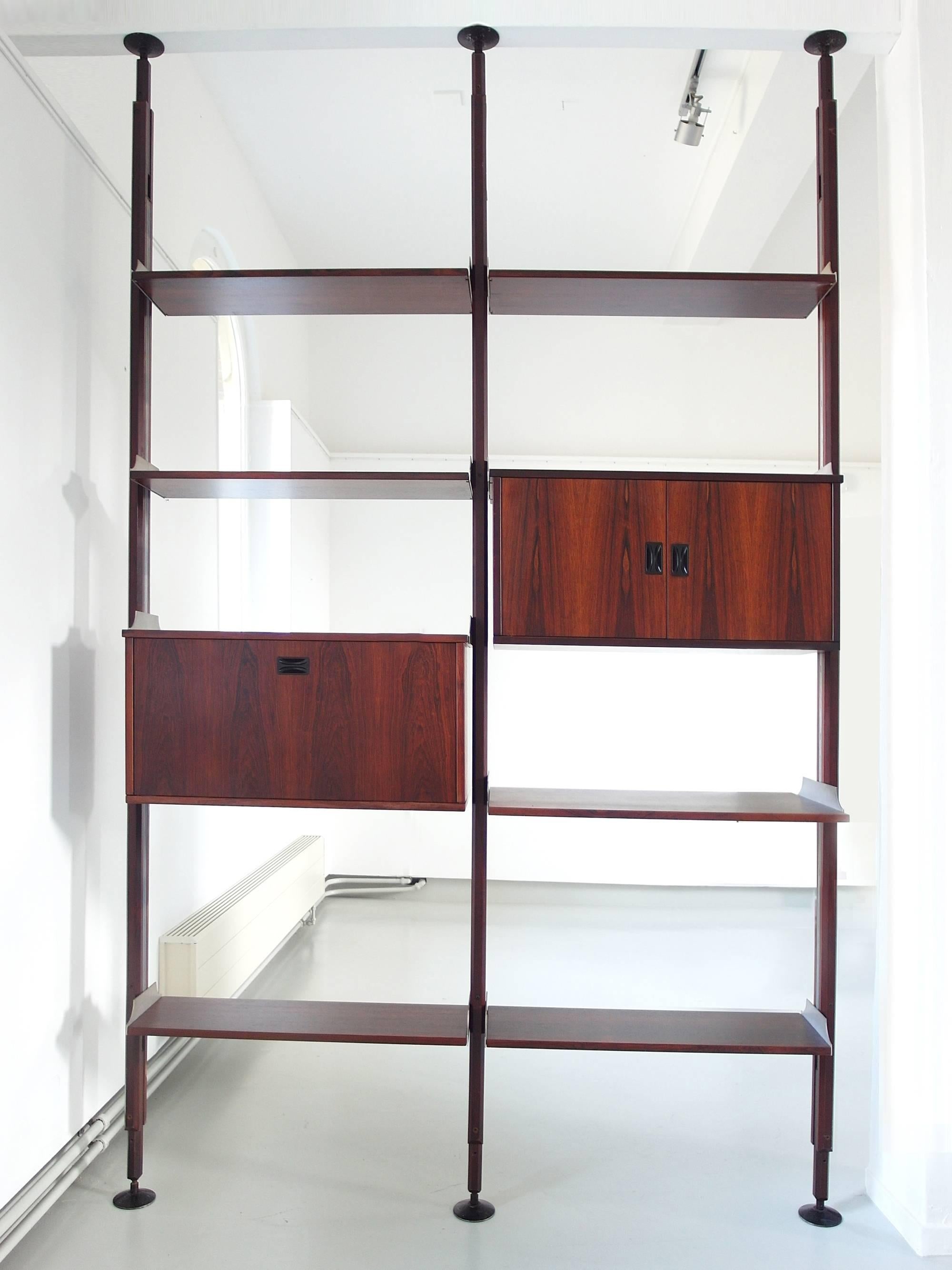 A beautiful shelving system by Stildomus, Italy, circa 1960. The library is composed of five small shelves, a large bookshelf and two cabinets, all made of luxury Caviuna hardwood. The shelves and cabinets can be composed easily according to your