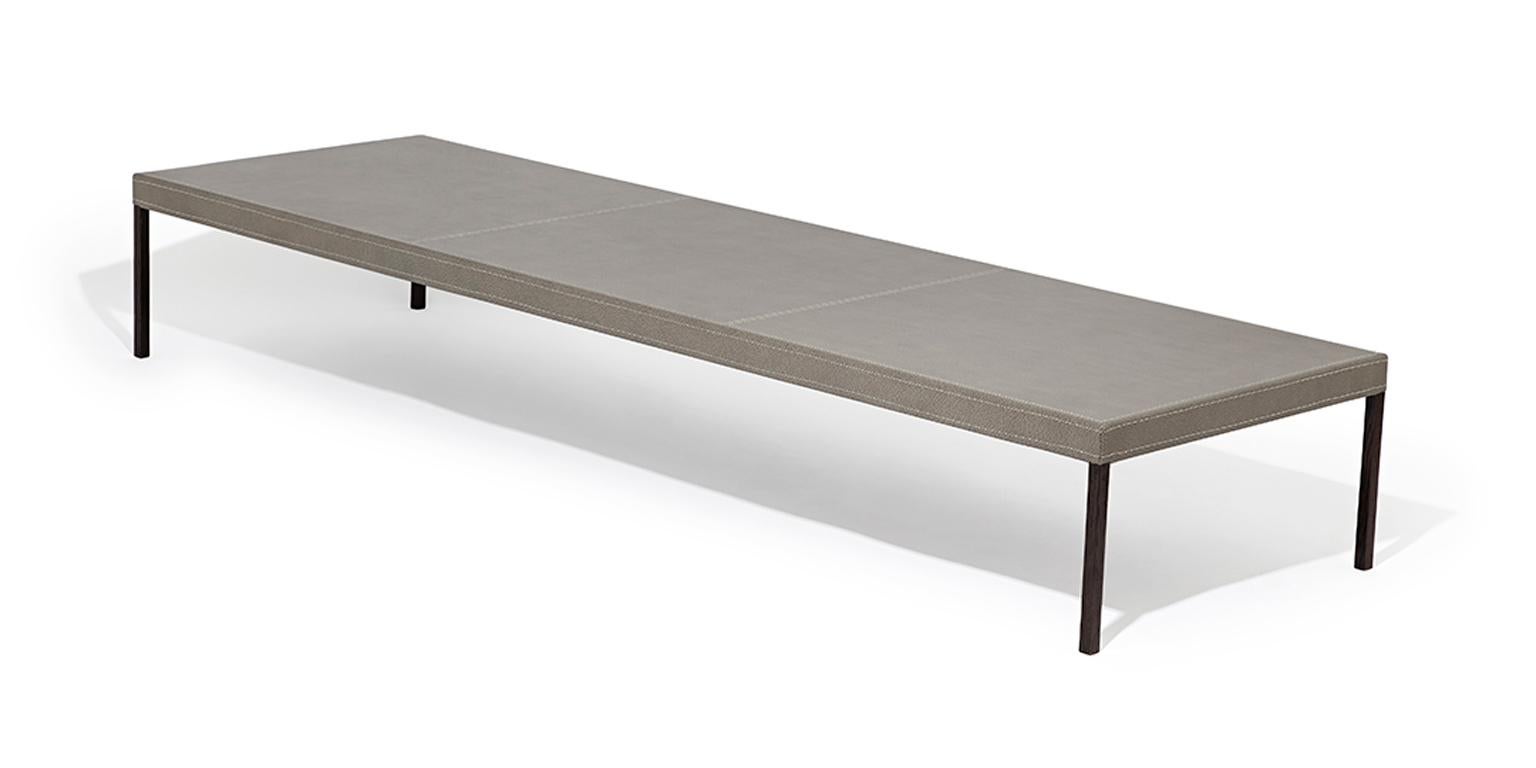 La table basse Stiletto s'intègre parfaitement aux décors traditionnels et modernes. Il est proposé avec un plateau recouvert de cuir et des pieds fins et sexy recouverts de wengé.