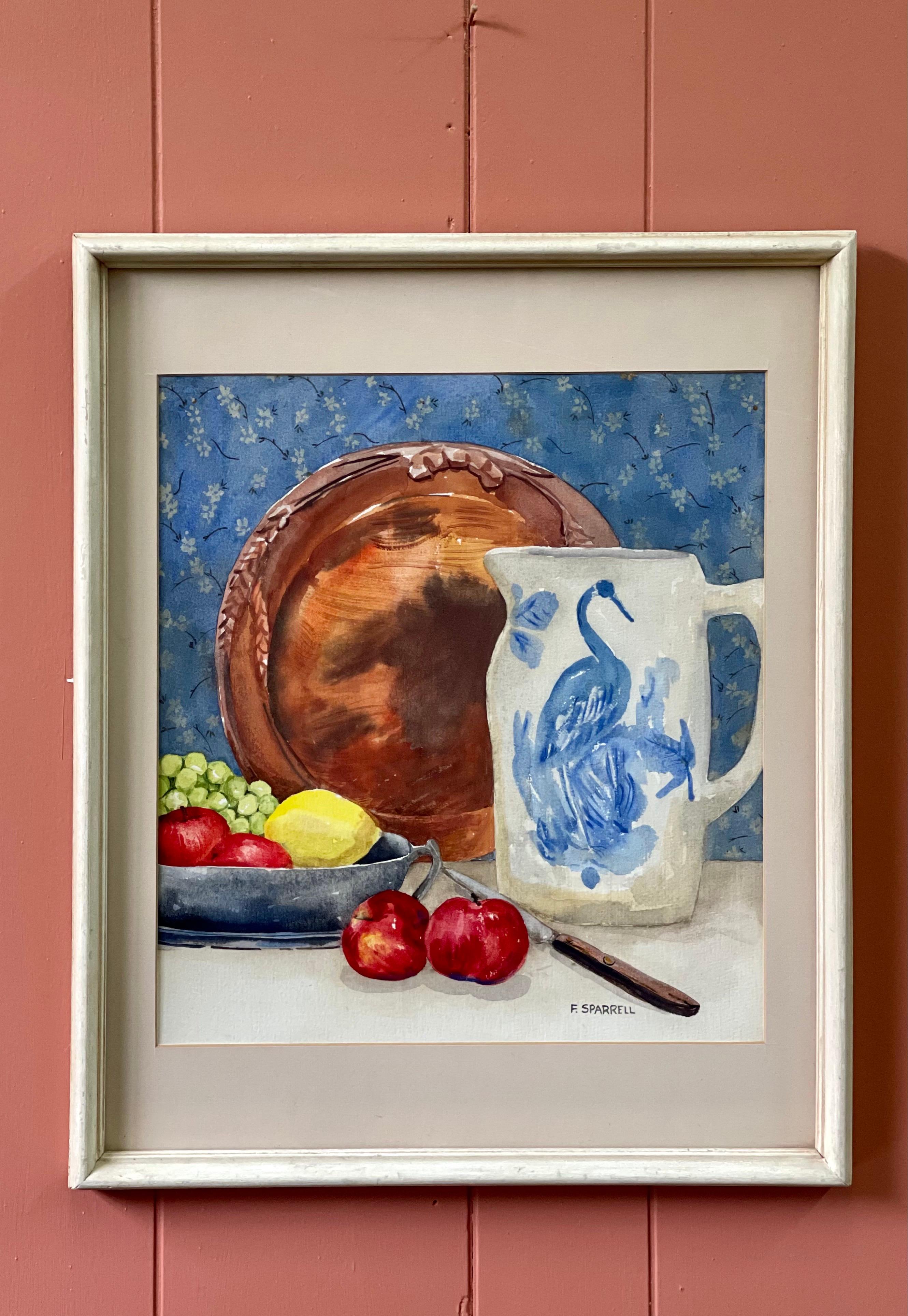 A beautifully composed still life watercolor of blue and white petite floral print wallpaper in the background layered with a copper plate, blue and white porcelain pitcher decorated with a crane, and a pewter bowl of fruit in the foreground. The