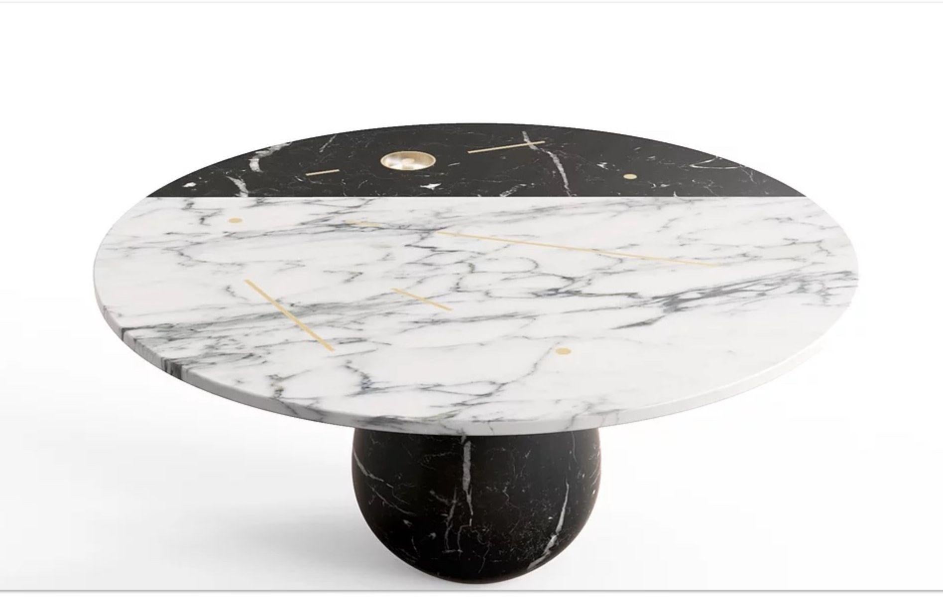 Stilla marble table by Marmi Serafini
Materials: Nero Marquinia, Arabescato Carrara, brass, resin
Dimensions: Ø 160, H 75 cm



Stilla is a round table which top, embroidered by simple and geometrical features, gives life to an elegant