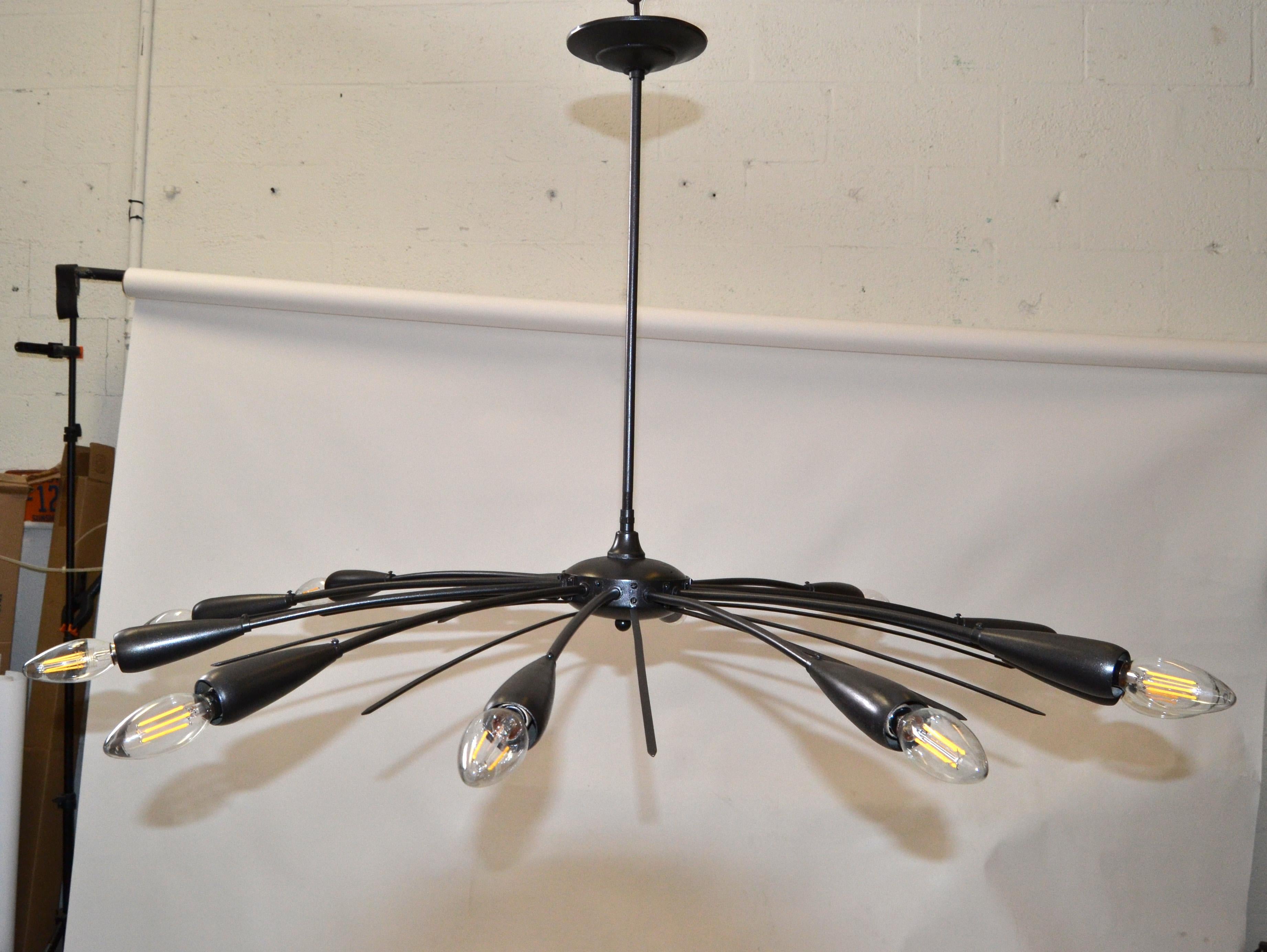 Stilnovo style 12 light spider chandelier in bronze finish over brass.
Made in Italy in the late 1960.
Recently restored and ready for Installation.
US Rewiring and takes 12 candelabra light bulbs with max 40 watts or LED bulbs.
Canopy measures