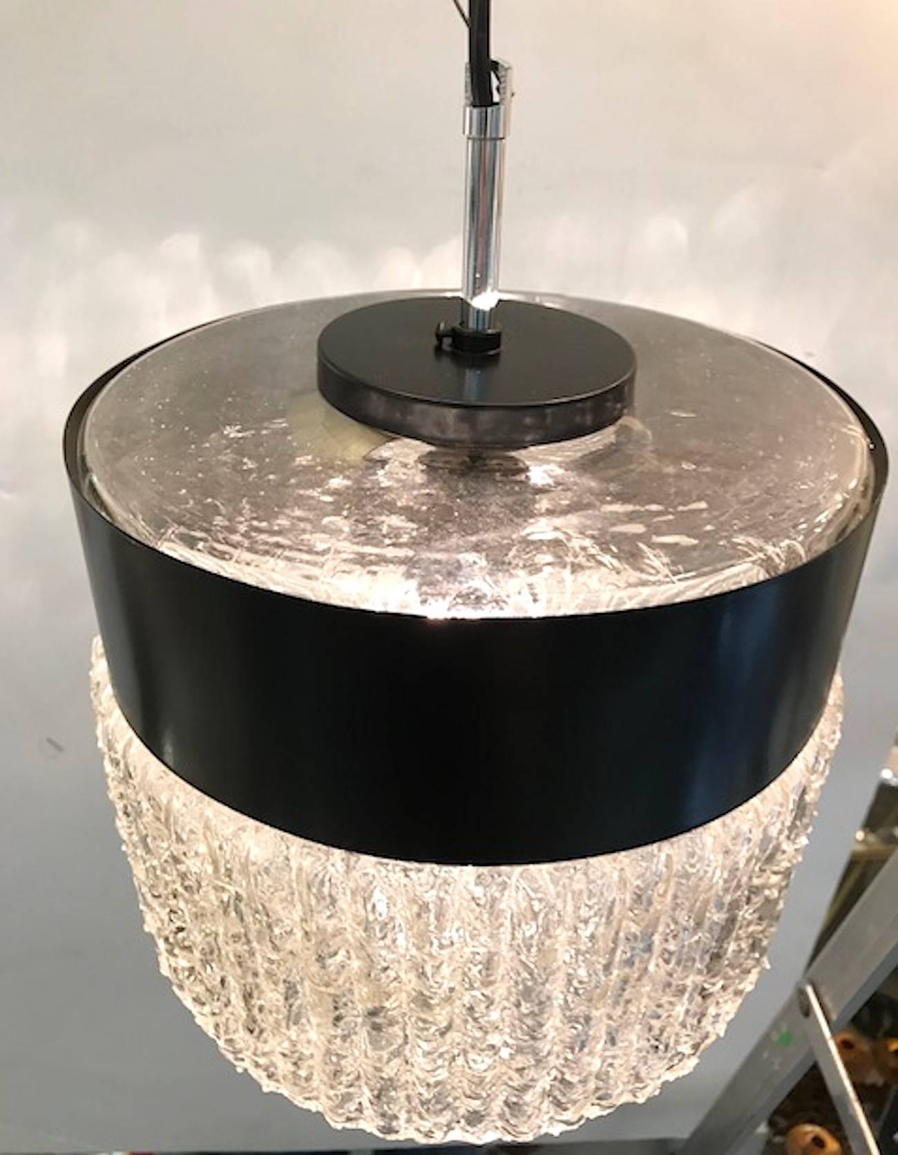 A circa 1950-1960 Italian pendant light in the manner of Stilnovo. Black enamel band sits around the top of at the glass shade. The shade is blown and hand formed glass with textured glass and scallop sides below the band. The black enamel bands