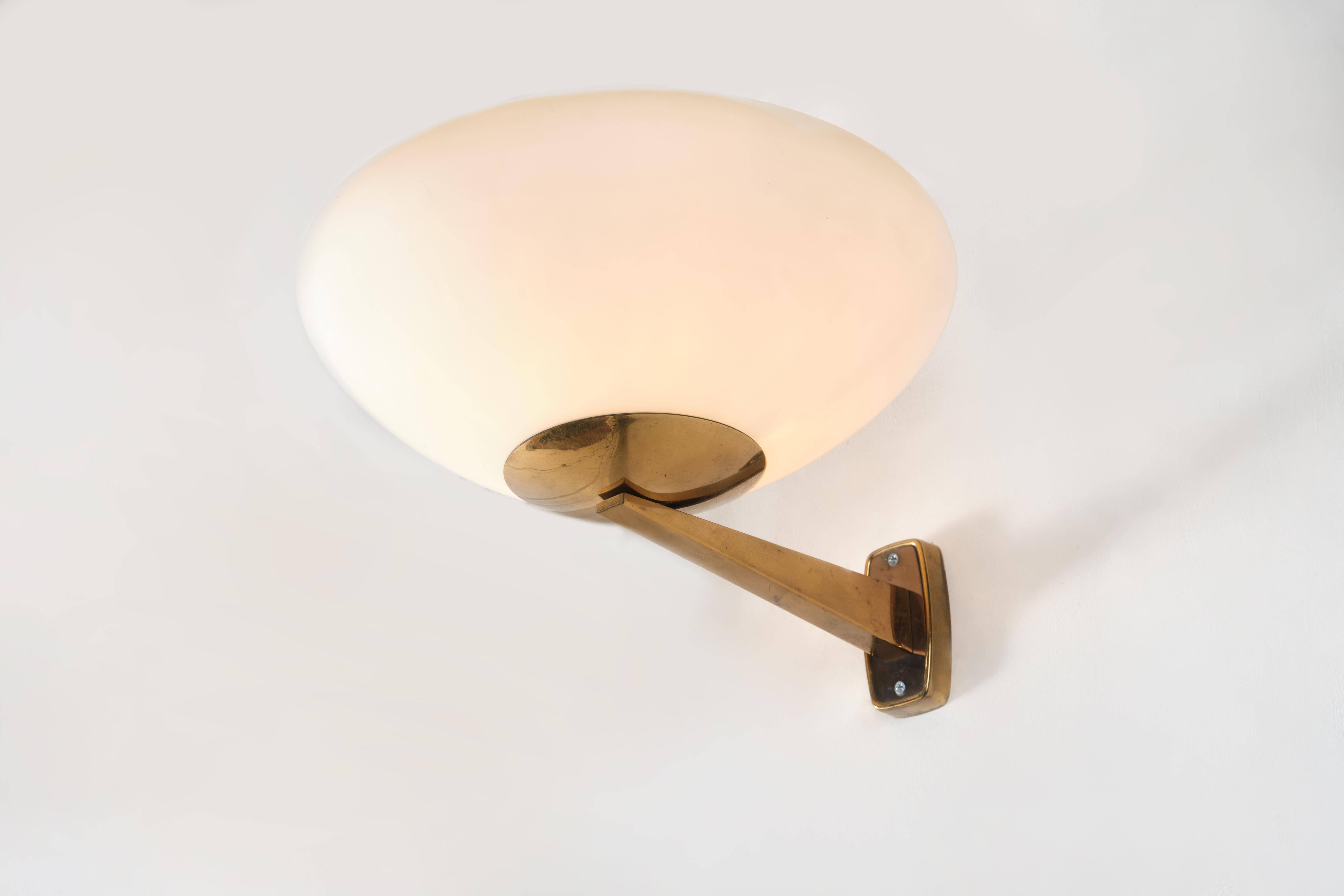 This wall lamp was produced in Italy by Stilnovo in the 1960s.
It is made from a brass structure with a white Opaline sandblasted shade.
This piece will add a touch of Italian design style to your interiors.