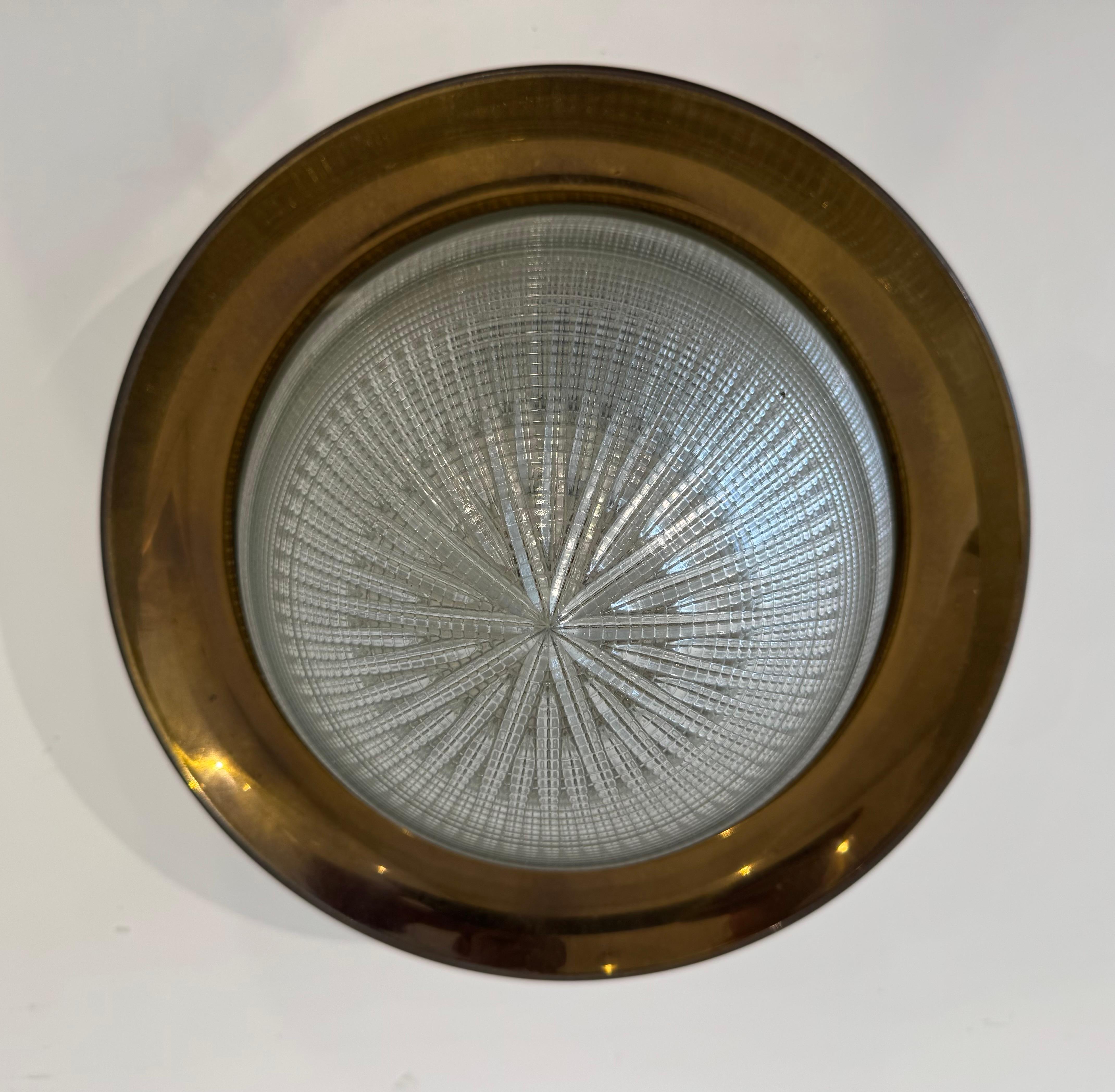 A rare 1960s Italian Mid Century ceiling lamp composed of an aged brass/bronze fixture and a Holophane glass dome shade. Crafted by the famous Italing lighting maker, Stilnovo. Signed. Rewired standard A socket.