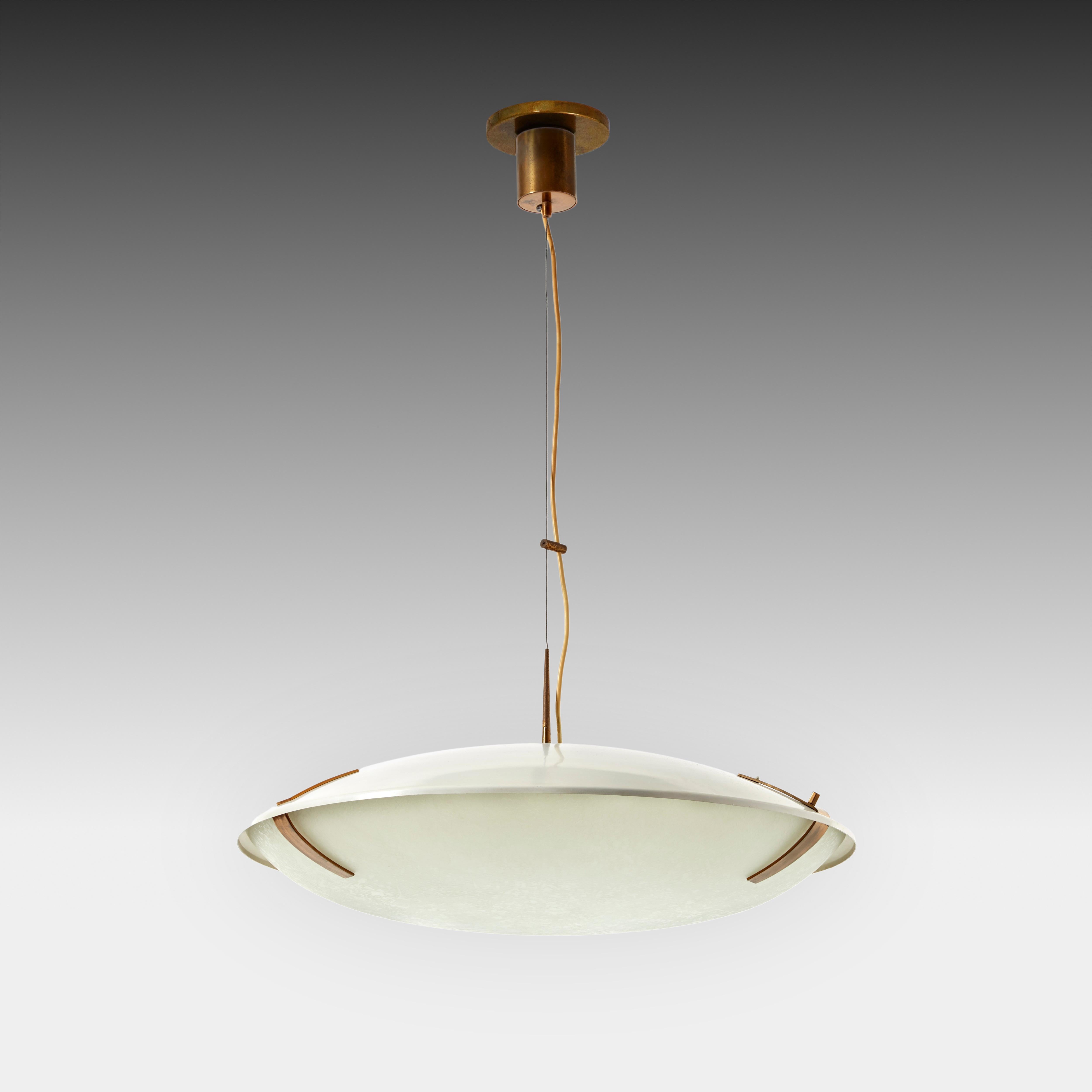 Stilnovo adjustable pair of adjustable pendants or suspension lights model 1140 each with white enameled aluminum shade suspending textured glass dome shade with brass fittings and suspended from its original brass canopy with custom ceiling plate.