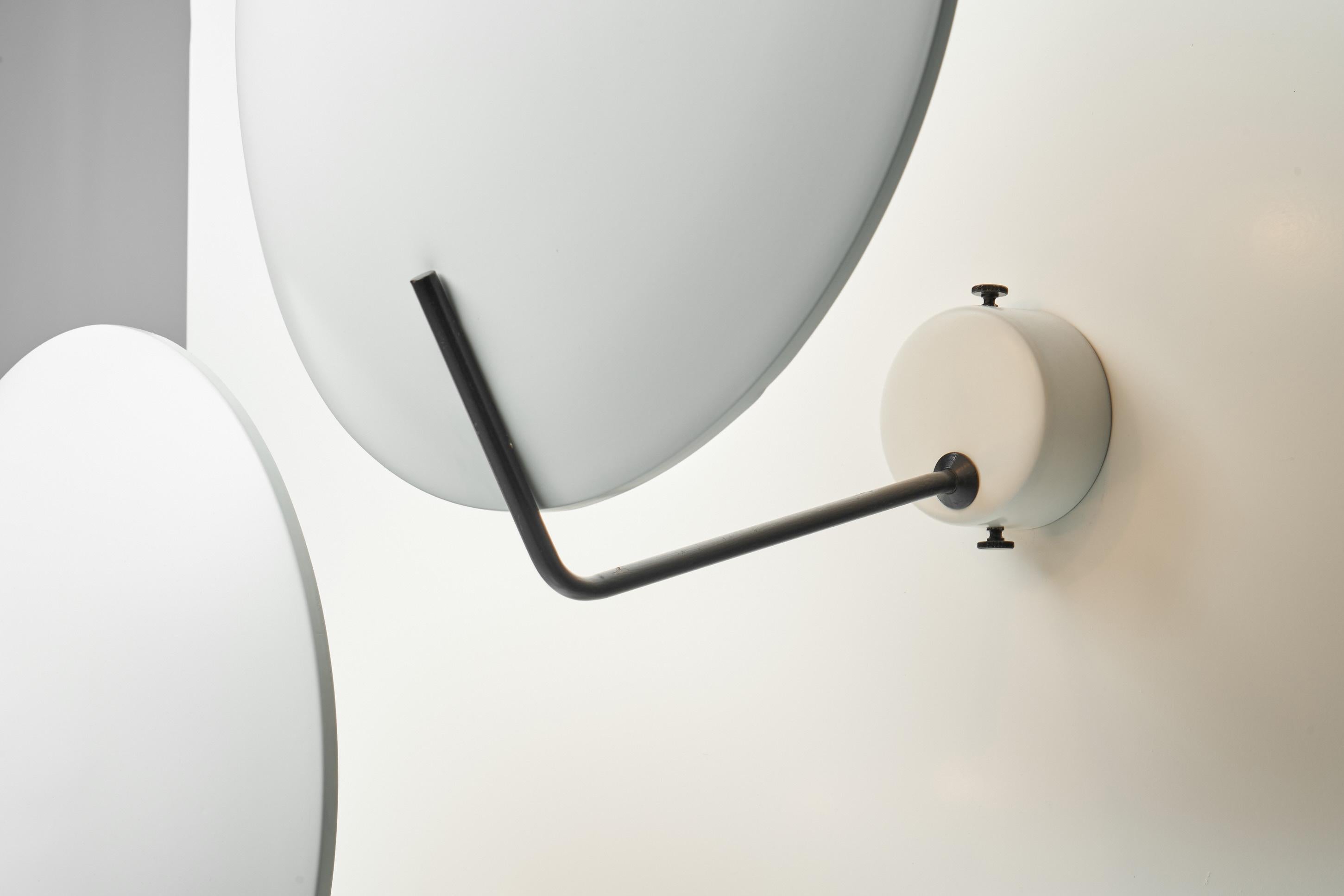 Nice and minimalistic pair of 'Model 232' wall lamps, designed by Bruno Gatta and manufactured by Stilnovo, Italy 1954. The large bowl-shaped shades are supported by a black painted metal arm, the wall mounted cap is the same finish as the shade and