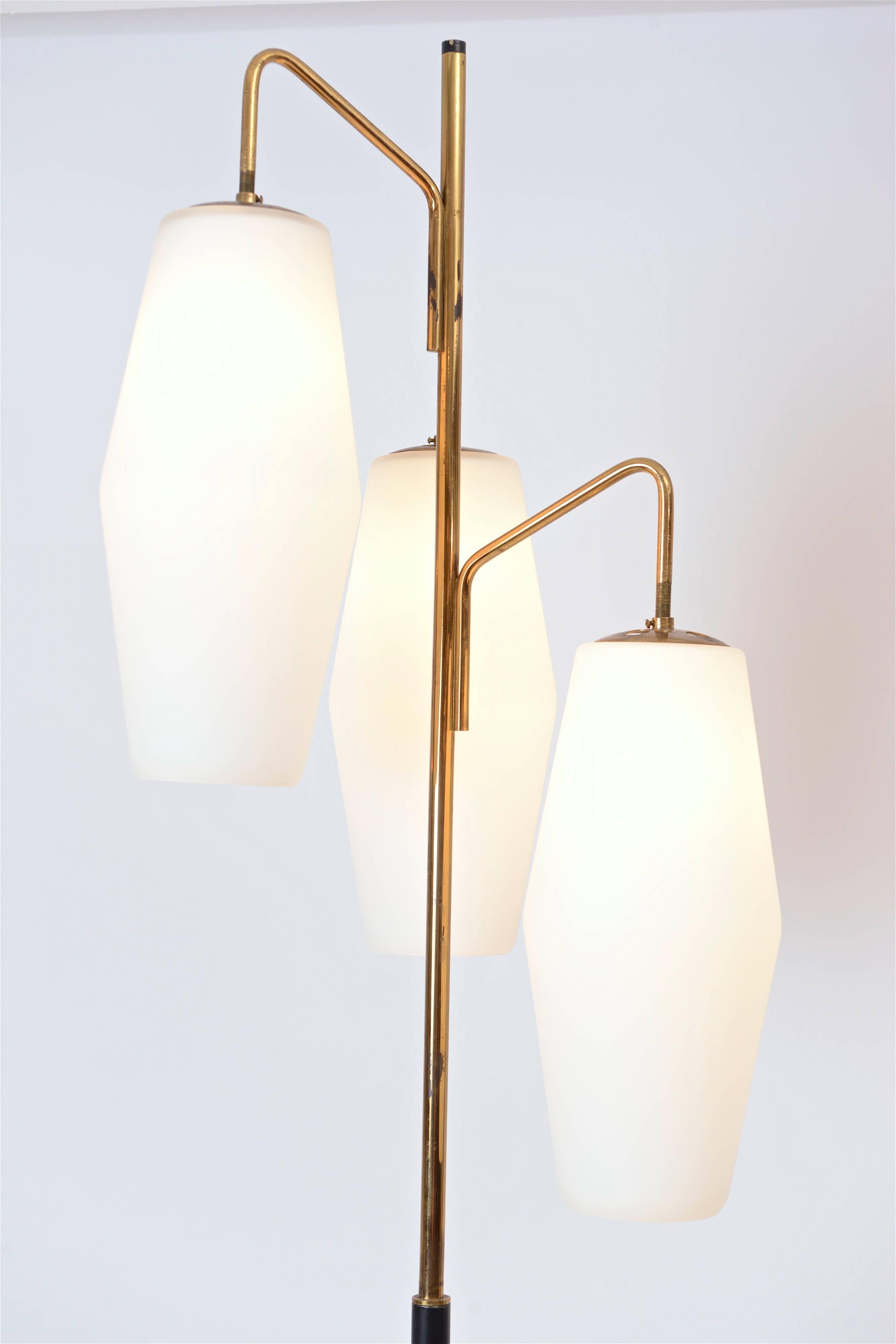 A wonderful three-shade opaline floor lamp by the celebrated Italian lighting company, Stilnovo. Produced in the early 1960s, the ‘4052’ design features three elongated milk-glass shades, all of which are staggered at different heights. The lower