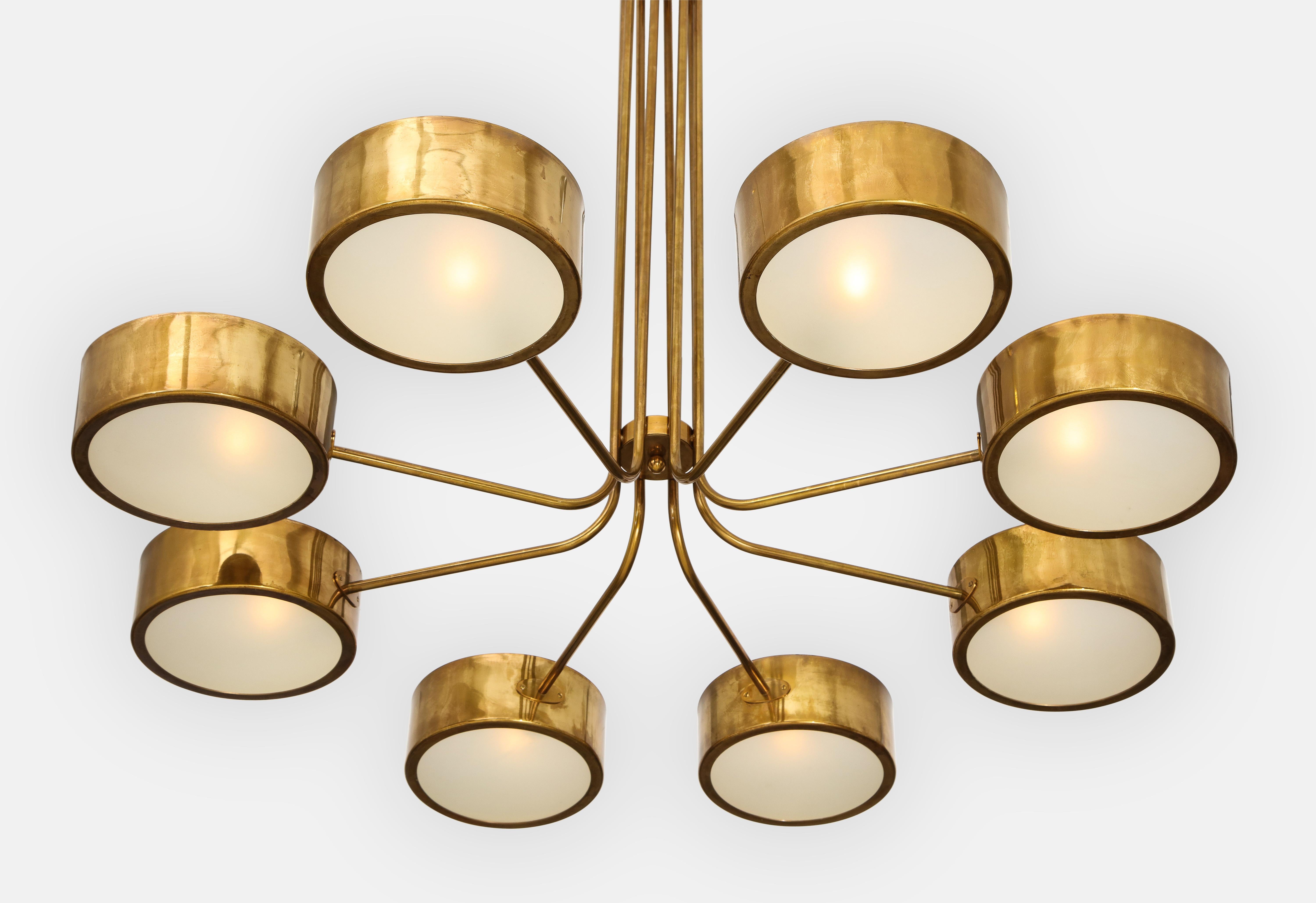 Stilnovo striking large chandelier consisting of original disc canopy with eight long brass arms dropping around a similar central disc decoration ending in circular brass and inset frosted glass shades, Italy, circa 1960.
