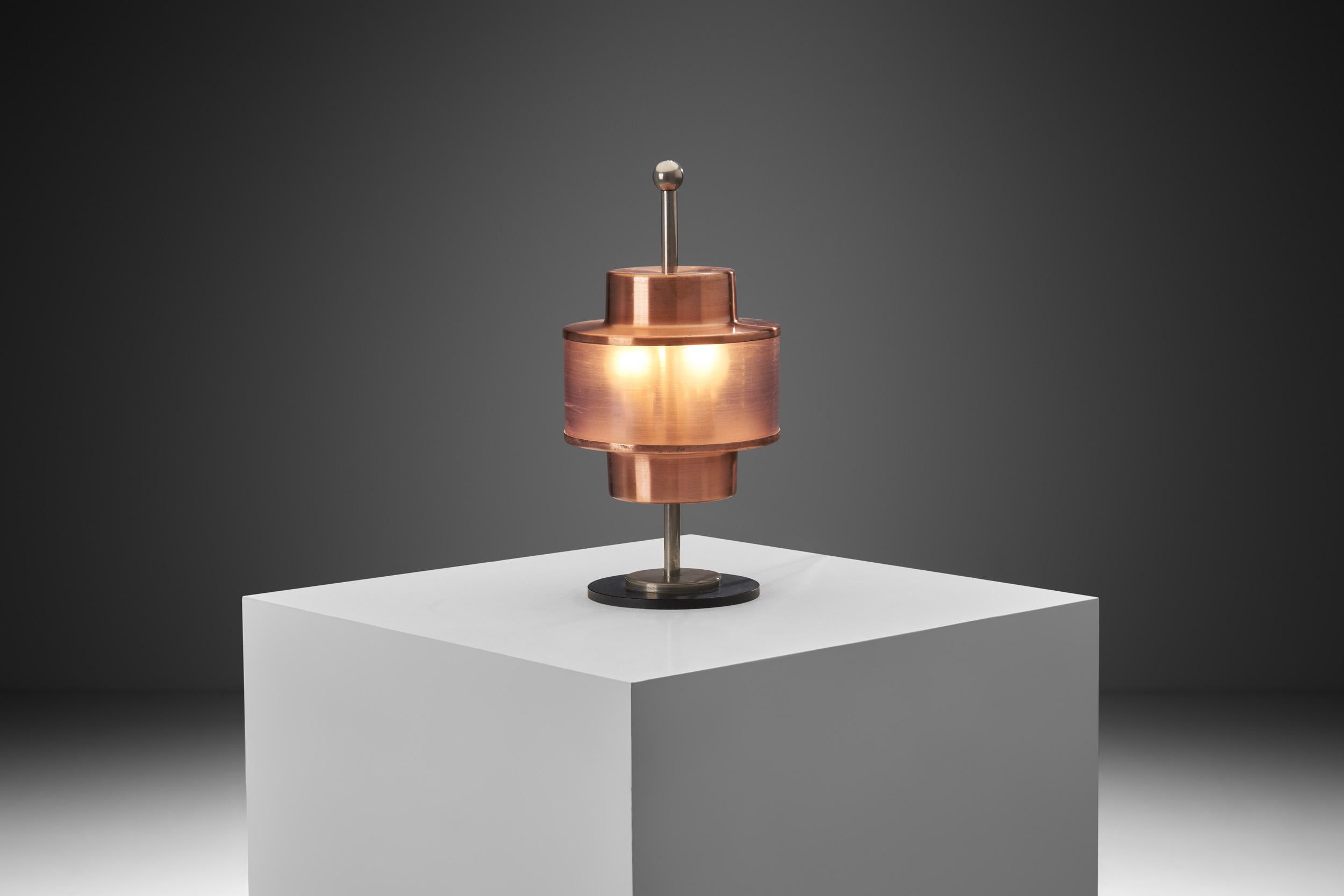 This characteristic Stilnovo table lamp is the definition of an eye-catching design. Decorative lighting is basically the fourth layer of illumination, the jewellery of the room. This lamp contains the comfort of ambiance lighting, the efficiency of