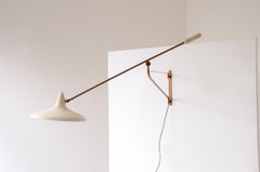 Stilnovo adjustable lamp with a brass stem and metal shade.