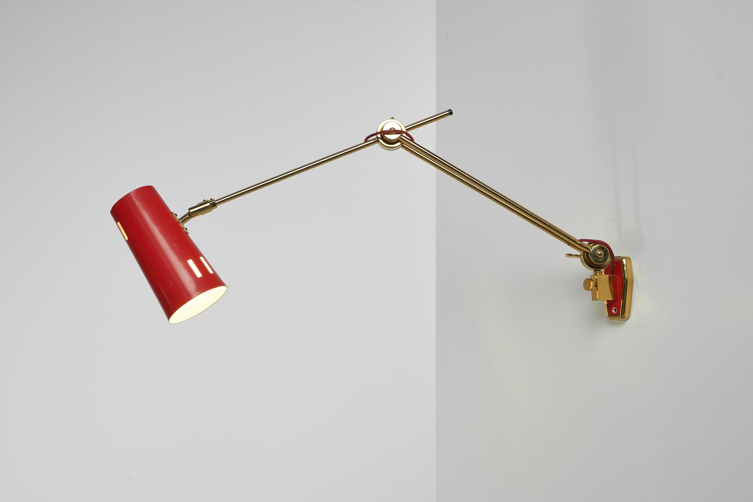 Stunning fully adjustable wall lamp designed and manufactured by Stilnovo, Italy 1960. The lamp has a super quality solid brass adjustable arm, which can rotate and can be adjusted in numerous positions for many different purposes. Also the angle of