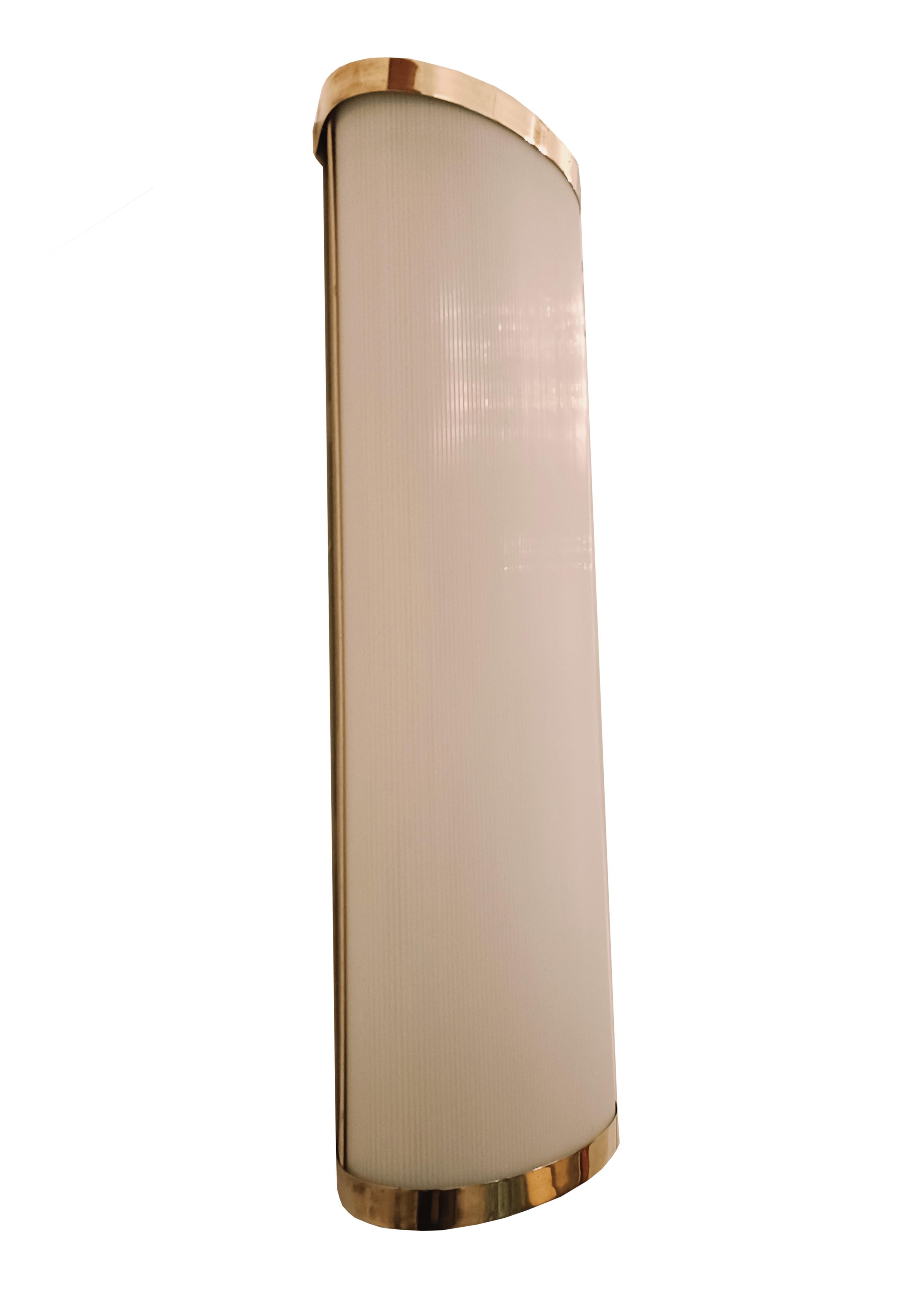 Large and rare wall lamp made with solid brass back plate and curved white methacrylate shade.