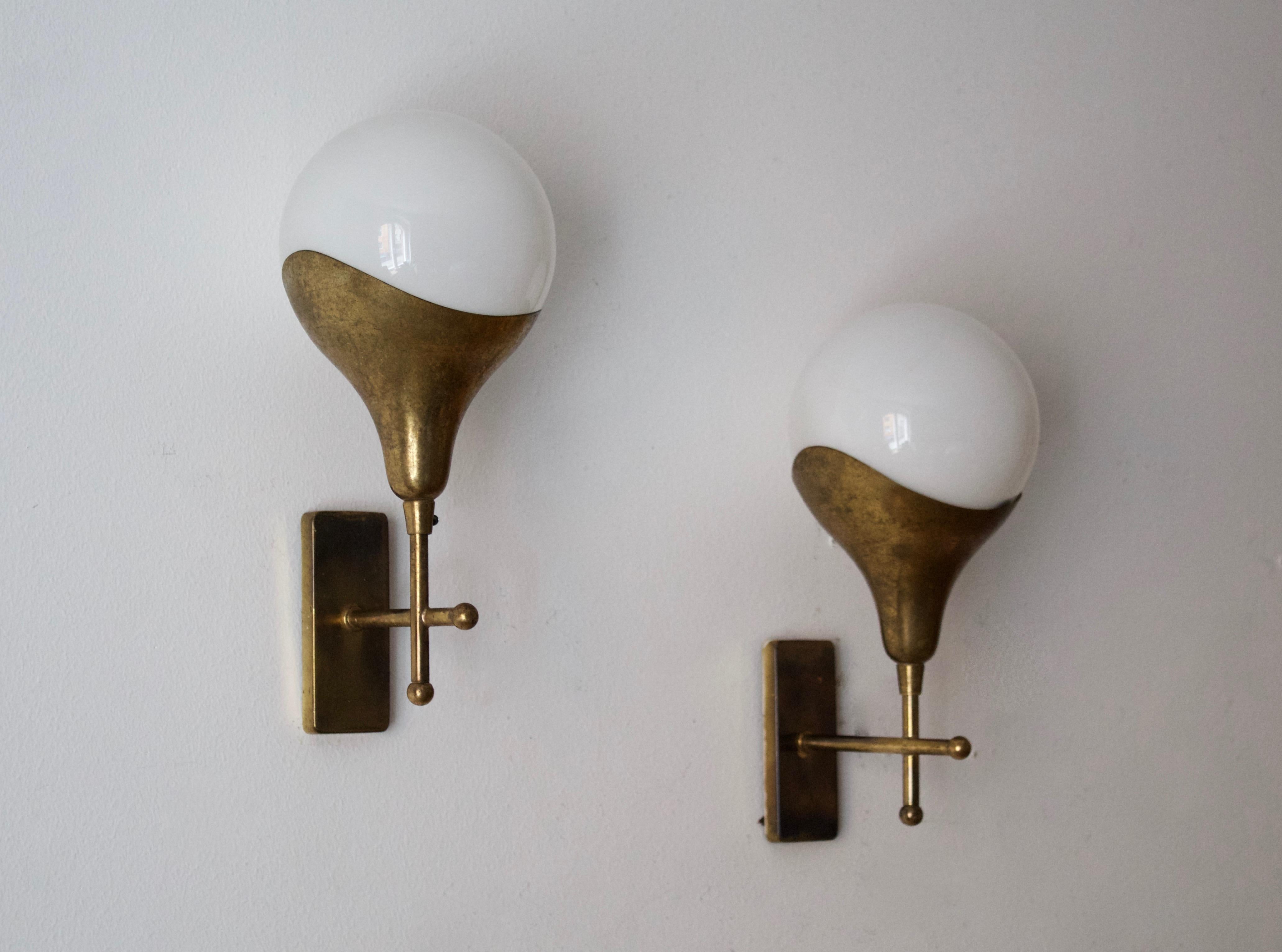 A pair of wall lights, design and production attributed to Stilnovo, Italy, 1950s. Features brass and milk glass.

Other designers of the period include Angelo Lelii, Gino Sarfatti, Max Ingrand, Serge Mouille.

 