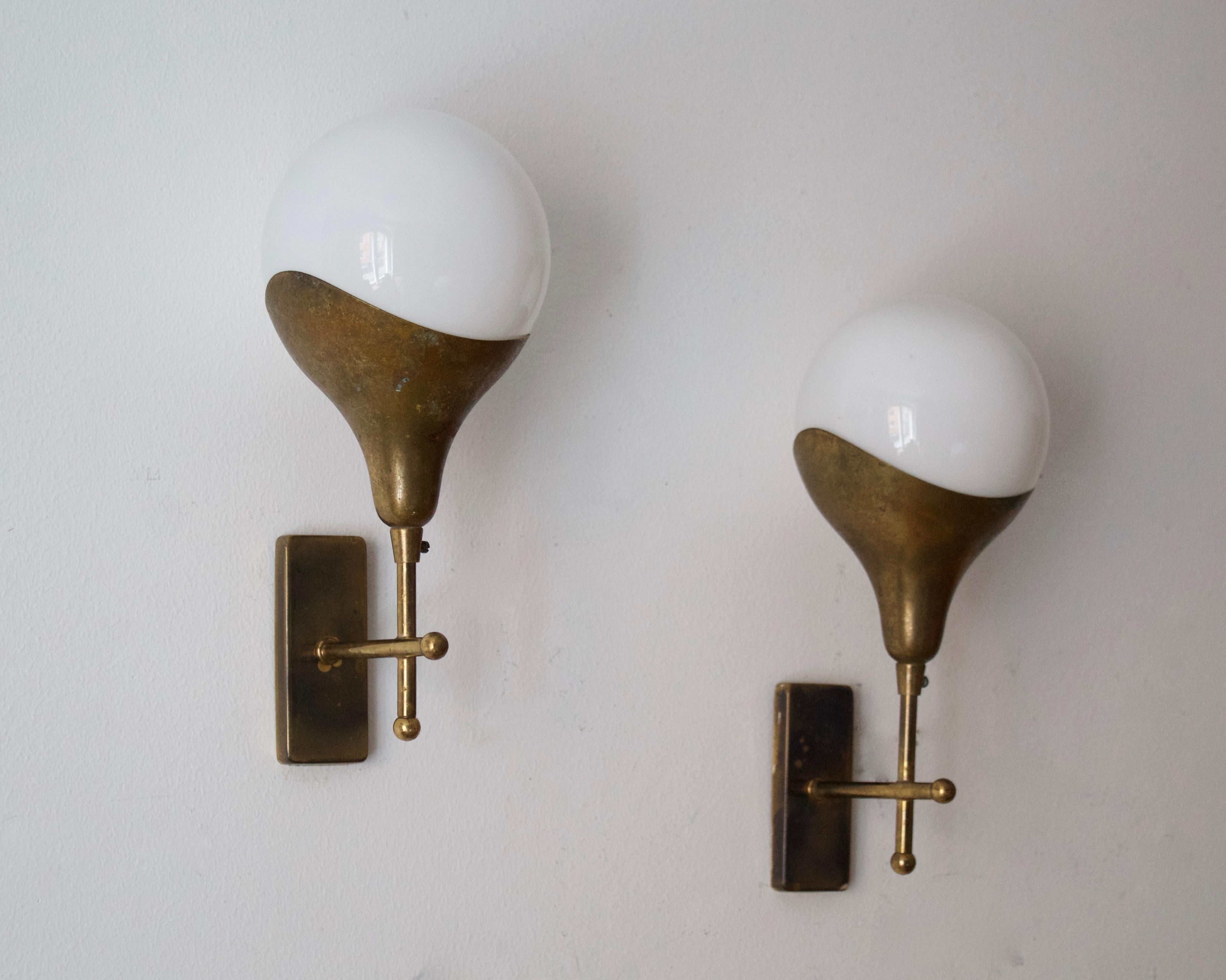 A pair of wall lights, design and production attributed to Stilnovo, Italy, 1950s. Features brass and milk glass.

Other designers of the period include Angelo Lelii, Gino Sarfatti, Max Ingrand, Serge Mouille.

 