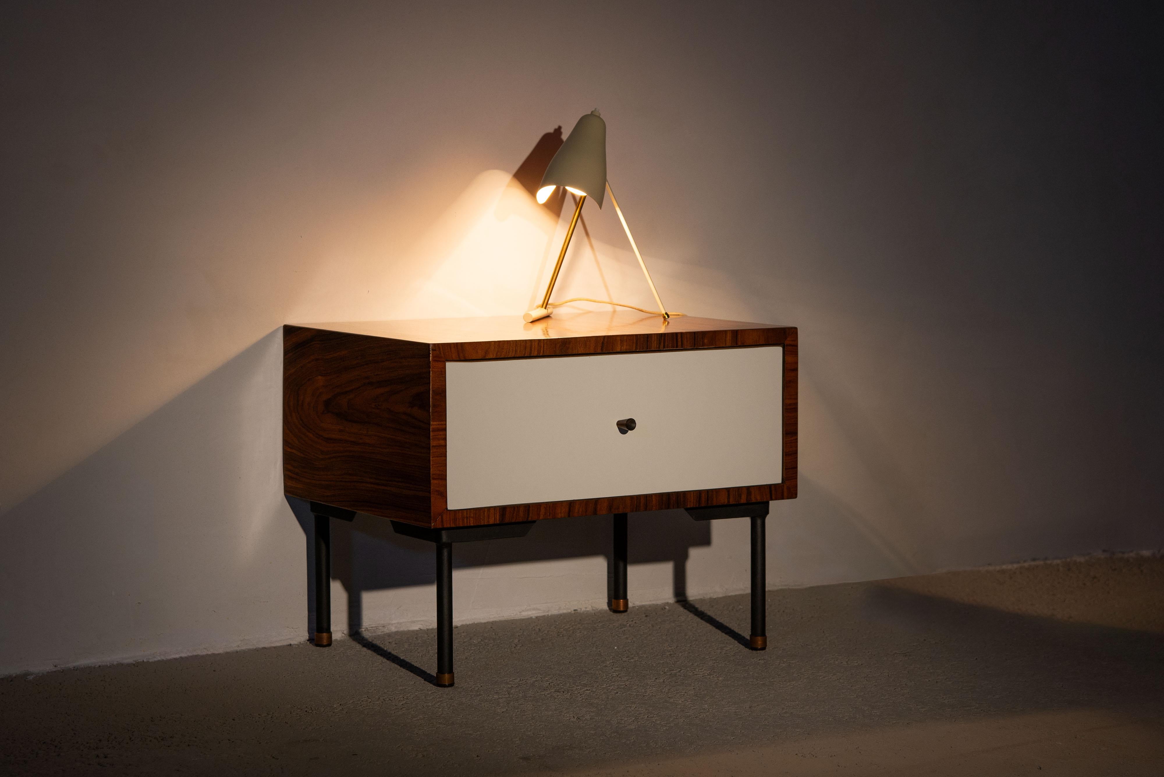 Discover the timeless elegance of a pair of bed lamps crafted by Stilnovo in Italy in the 1950s. These exquisite lamps boast a distinctive V-shaped base, expertly constructed from brass and partially painted to create an interesting play of