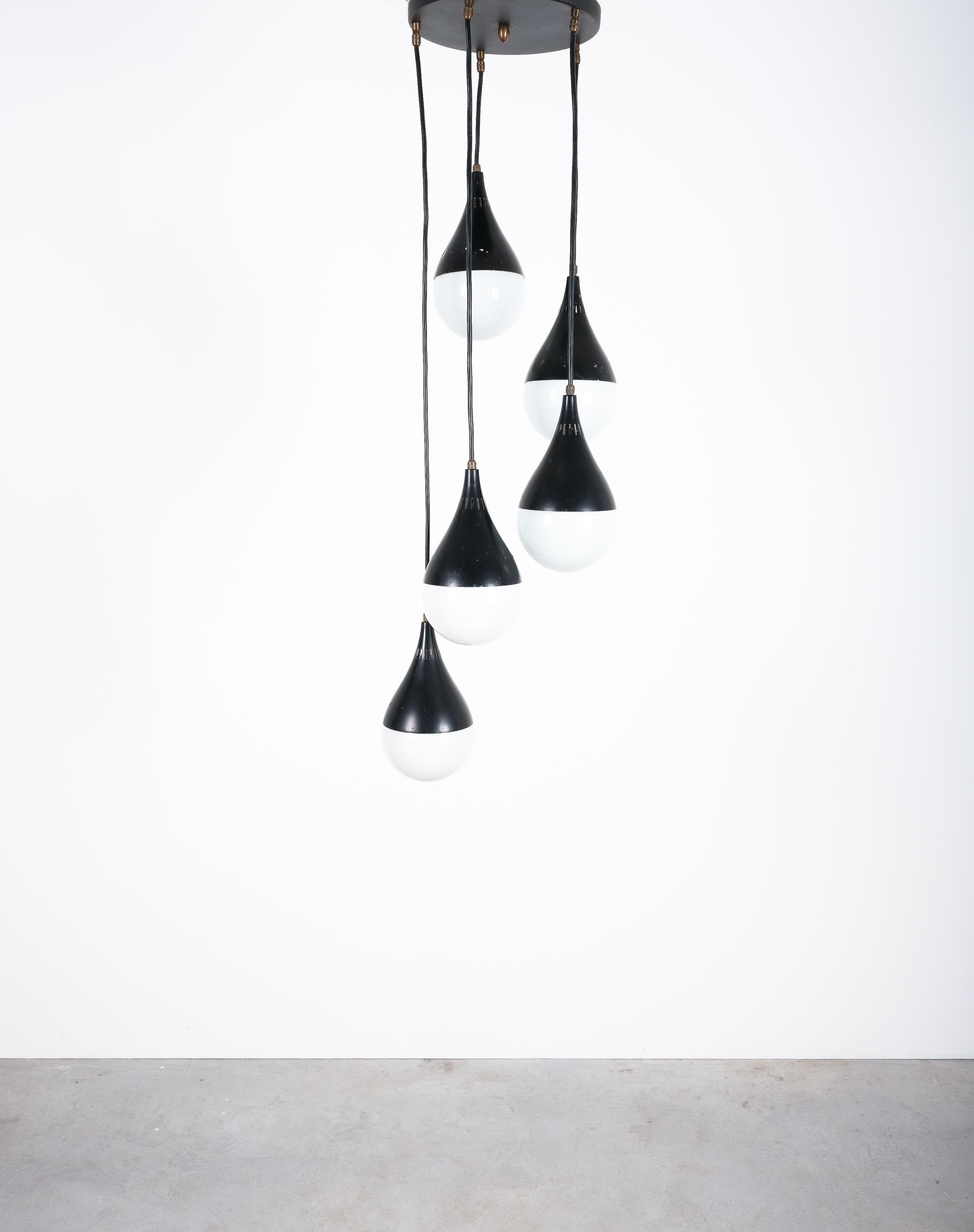 Stilnovo pear-shaped ball pendant with satin glass, Italy, circa 1950

Black mid-century modern suspension light by the Italian brand Stilnovo. Beautiful pendant light with multiple lacquered trumpet-shaped aluminum hardware and opal spheres