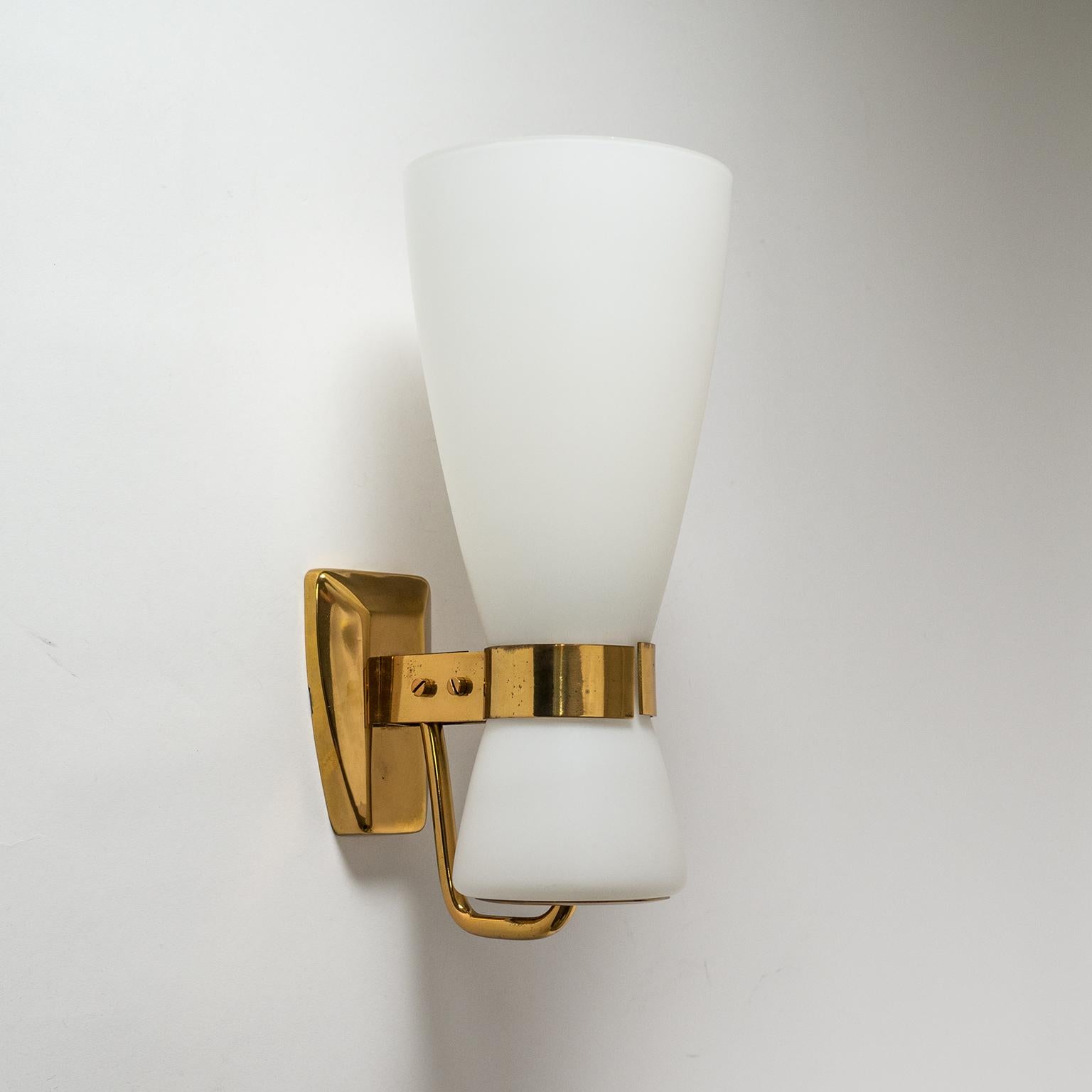 Elegant satin glass and brass wall light by Stilnovo, 1950s. The large tapered glass diffuser is held in place by two brass brackets. One original brass and ceramic E27 socket with new wiring. Original Stilnovo label.