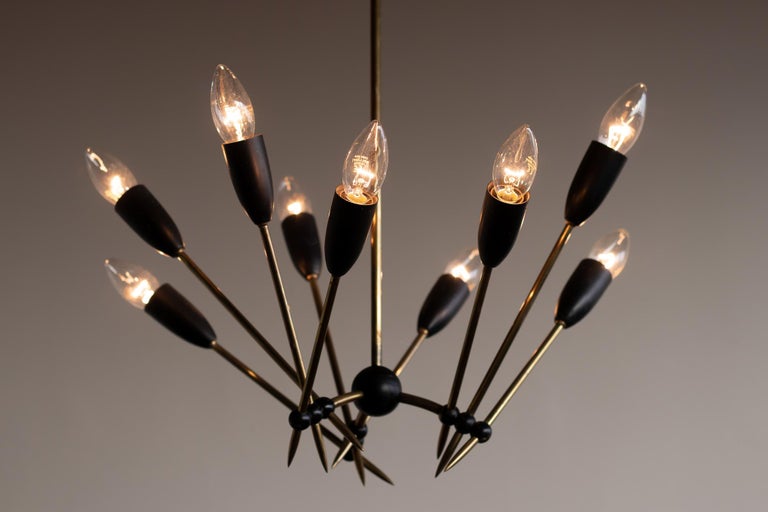 Very elegant chandelier with nine lights.
Frame and canopy in brass, ball joints in black enameled brass.
Great vintage 1950s period piece, rewired for use in the USA.
