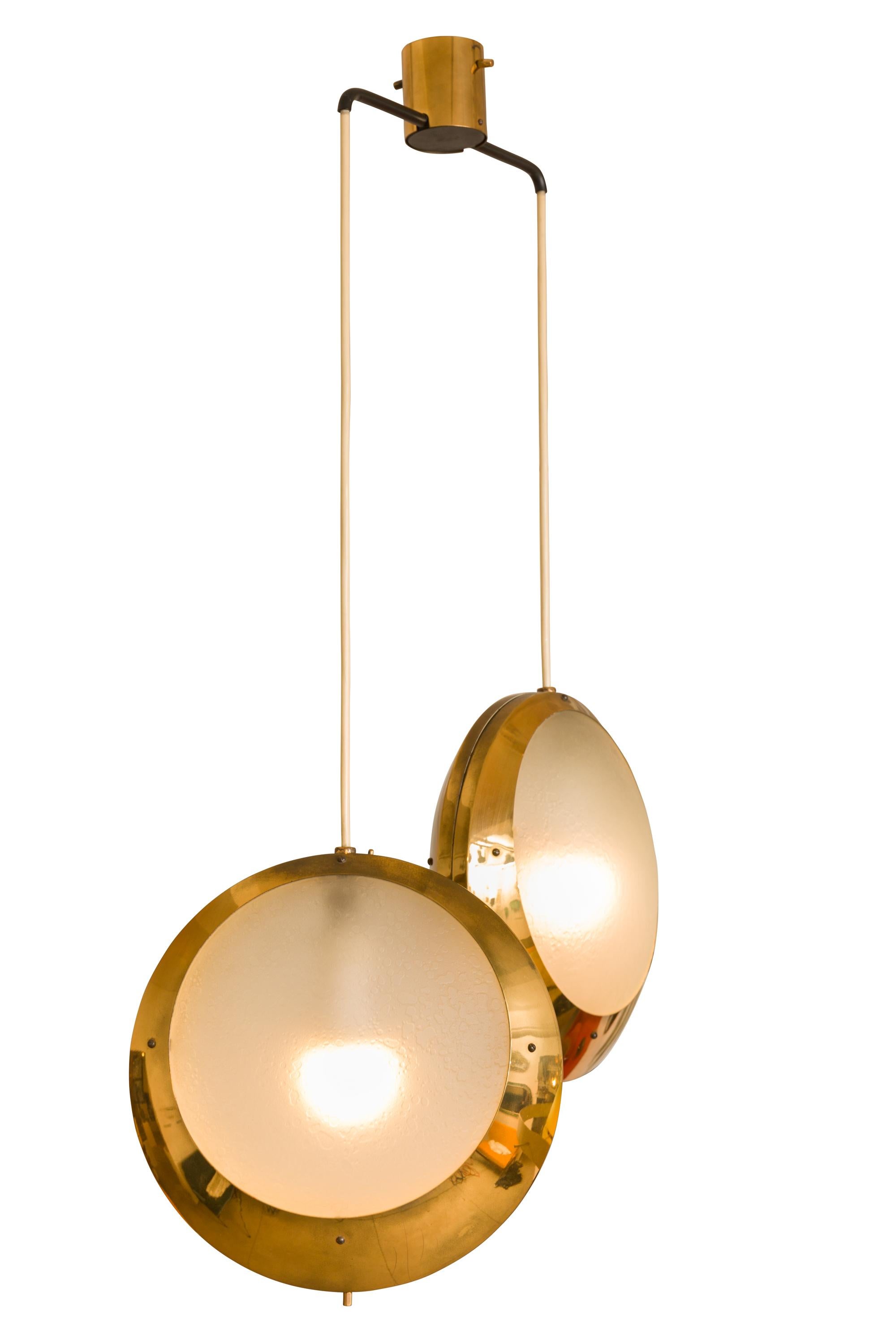 A rare and striking double pendant light by Stilnovo. The glass has a wonderful textured surface that diffuses the light and creates an additional appealing quality.