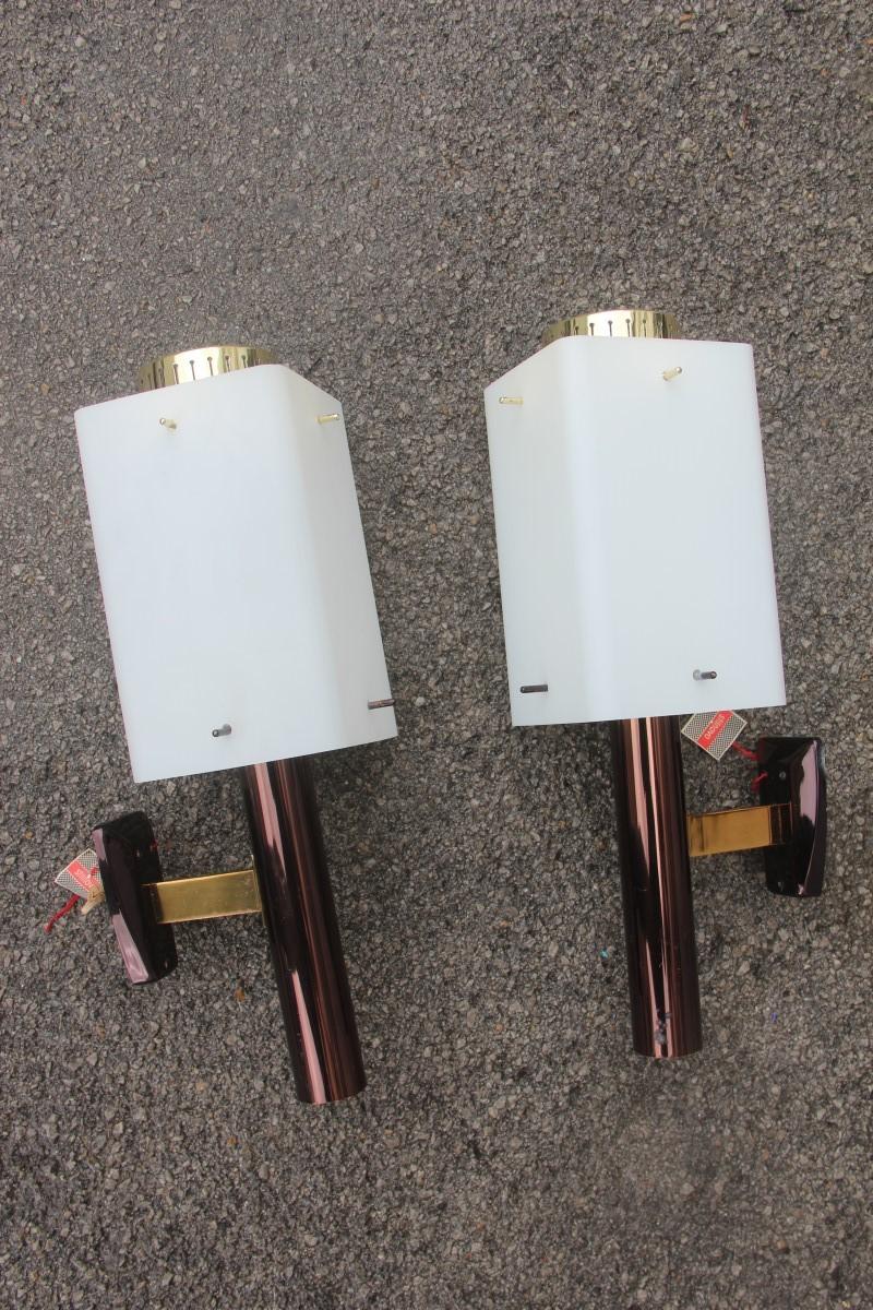 Stilnovo Bruno Gatta pair of sconces Mid-Century Modern white brass gold burnished.

This pair of wall lamps are original of their time, 
stock of the 1960s, structure in burnished and gilded brass, 
square glass with holes to support the glass,