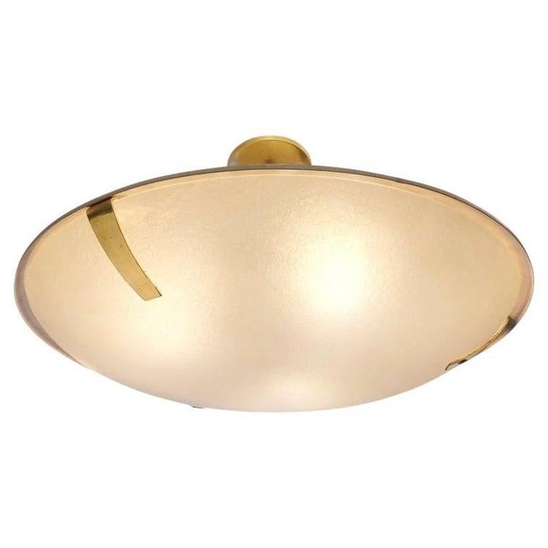 Graceful stilnovo semi-flush mount with a lacquered aluminum shell and a textured frosted glass shade. Brass fittings and canopy. Holds 3 E26 sockets. Marked with the original Stilnovo label. 

Condition: Excellent vintage condition, minor wear