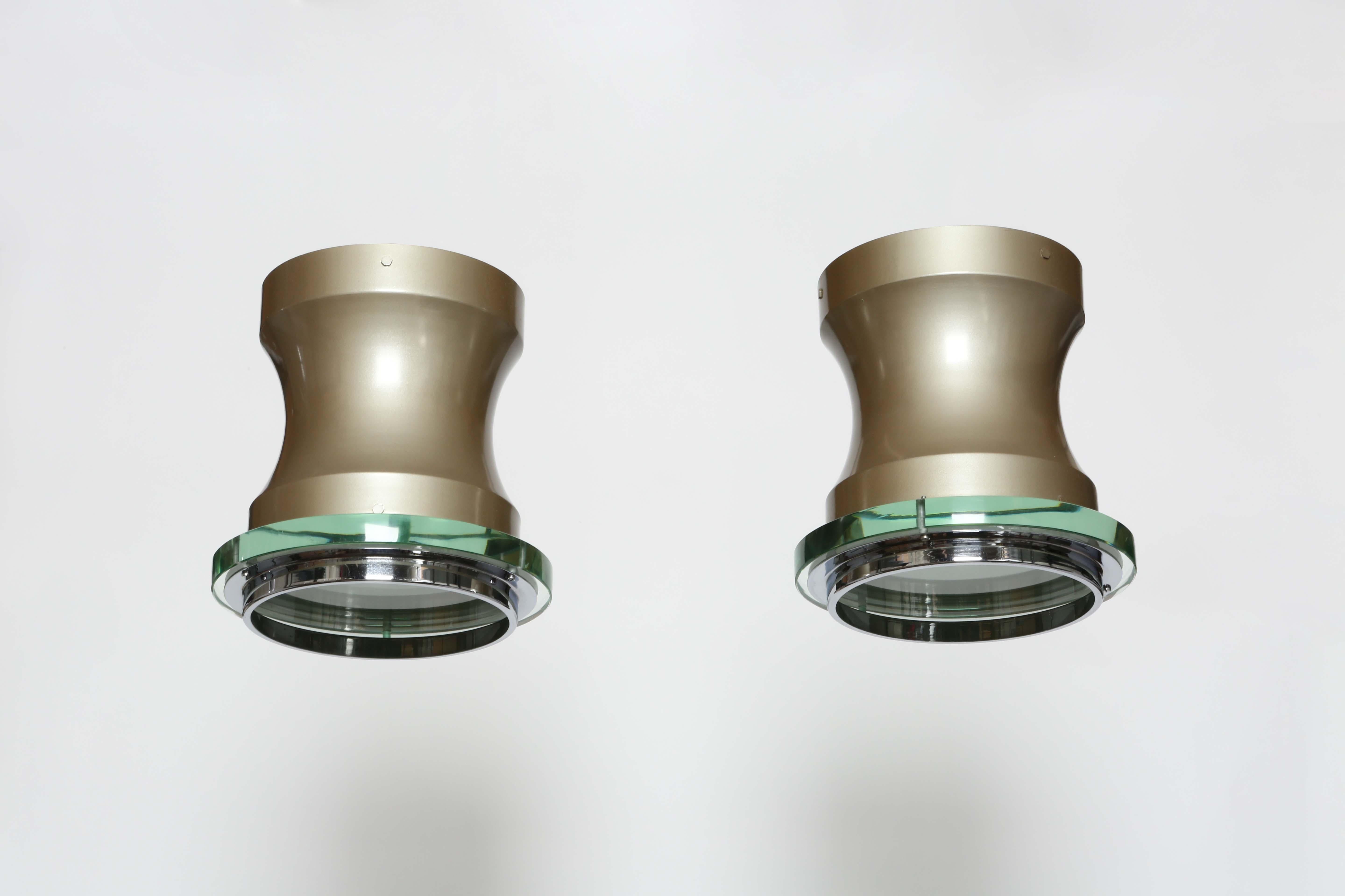 Stilnovo ceiling flush mount lights, a pair.
Designed and manufactured in Italy in 1960s.
Enameled metal, nickel plated metal, glass diffusers.
Label present.
Can be flush mounted or suspended.
One medium base bulb.
Complimentary US rewiring upon