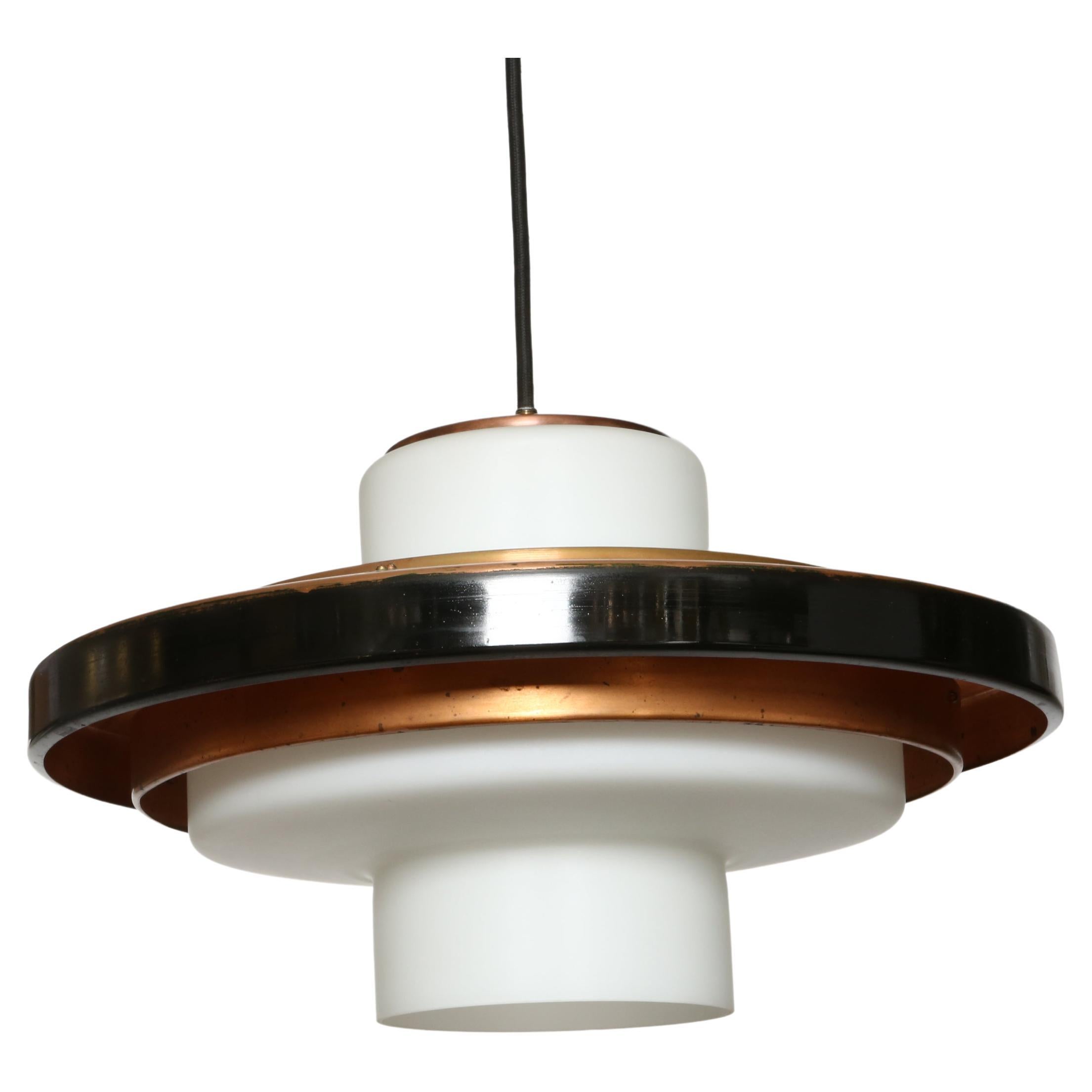 Stilnovo ceiling pendant model 1219, a pair.
Italy, 1960s.
Opaline glass, copper, enameled copper.
Black fabric cord.
One medium base socket.
Rewired for US.
Overall drop can be made shorter.

We take pride in bringing vintage fixtures to their full