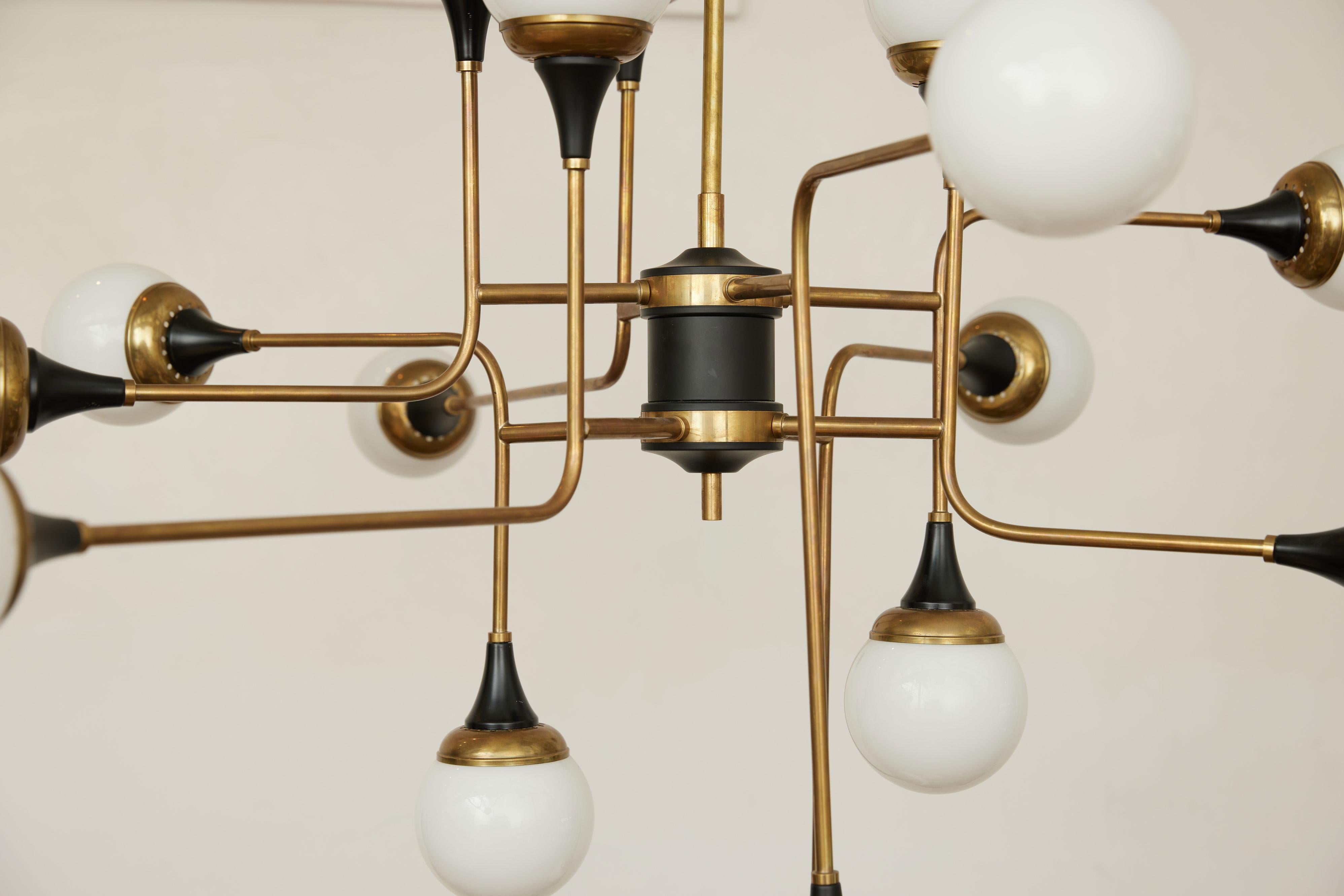 Stilnovo Chandelier 16 Light Brass Metal Opaline Glass, 1950, Italy

Marvelous Italian Chandelier Inspired by 1959 Stilnovo Design

Elevate your space with this exquisite Italian chandelier, a tribute to the iconic 1959 Stilnovo aesthetic. This