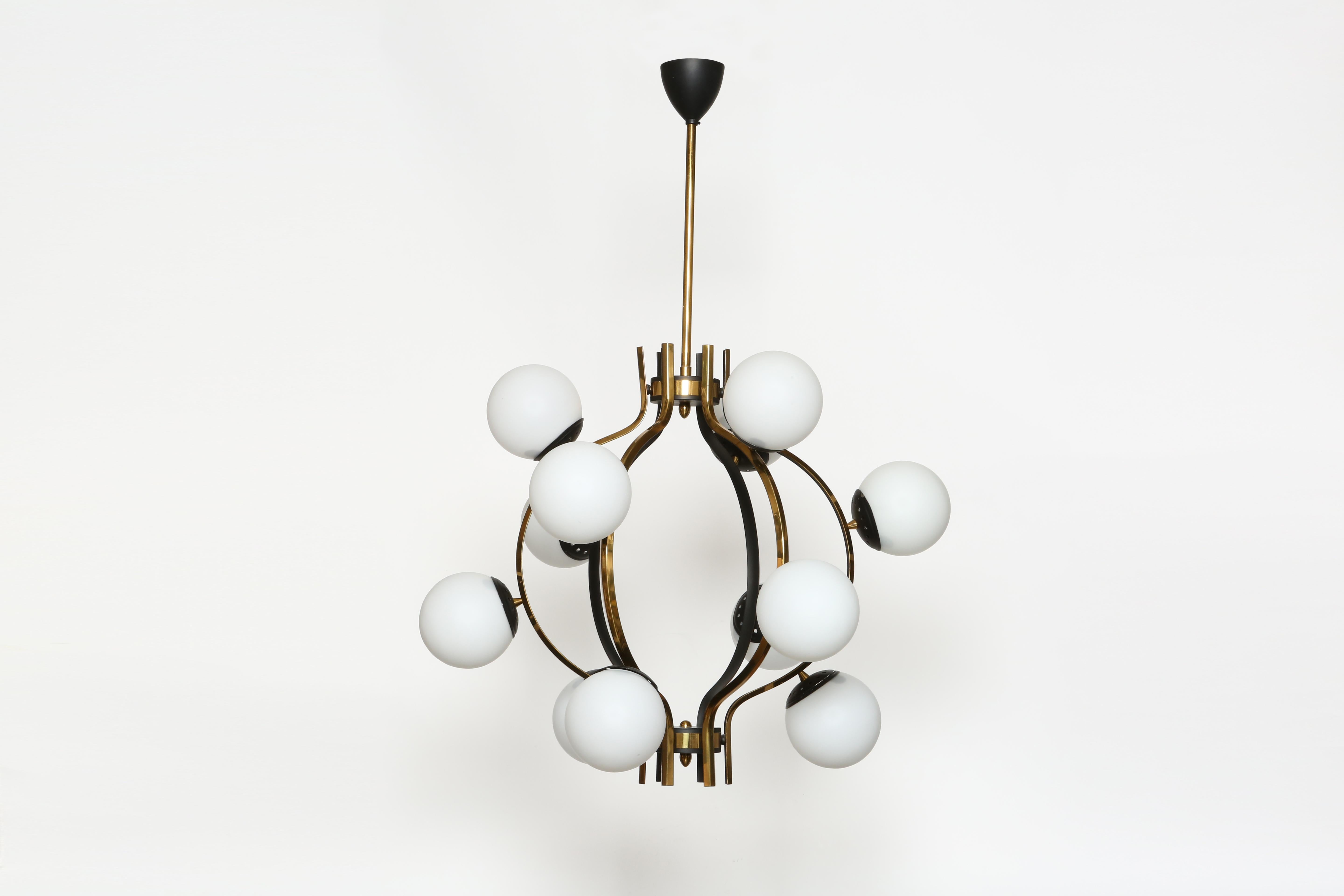 Stilnovo chandelier.
Italy 1960s
Made with opaline glass, brass, enameled metal.
12 globes.
Takes 12 Edison base  bulbs.
Complimentary US rewiring upon request.
Overall drop is adjustable.
Body of the chandelier is 22 inches in height.

We take